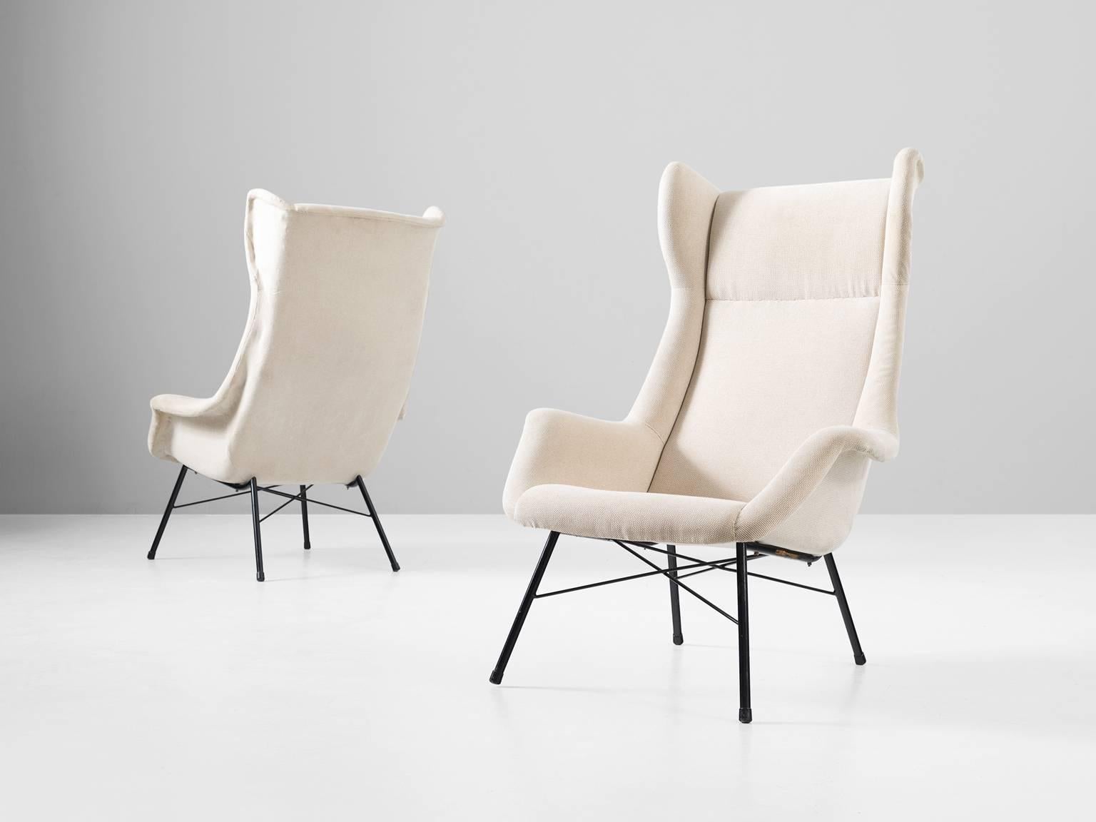 Pair of lounge chairs, in fabric and metal by Miroslav Navratil, Czech Republic, 1960s. 

Modern set of two high back lounge chairs. These easy chairs have a beautiful shaped shell and interesting metal frame. The shell shows beautiful lines and
