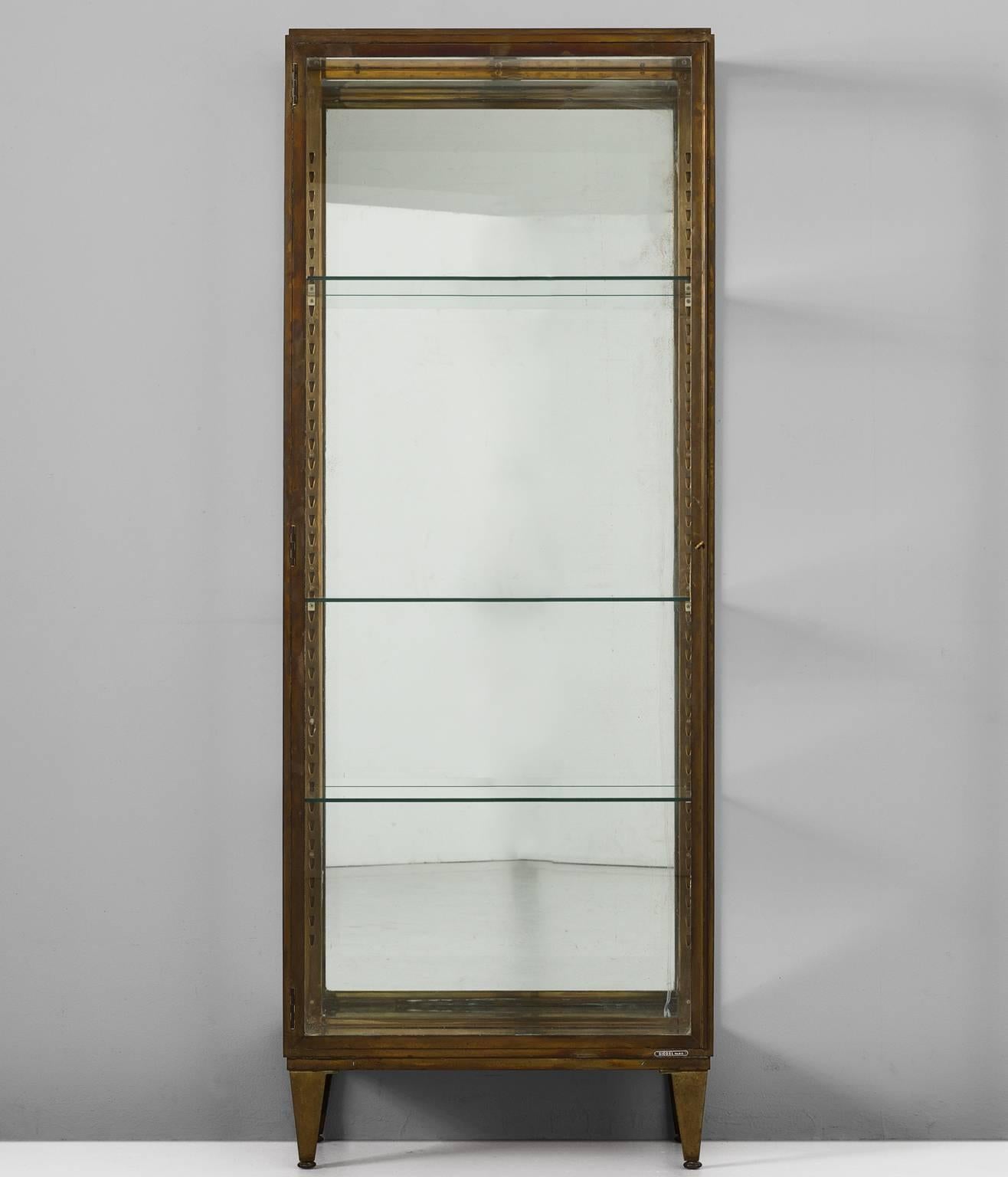 Vitrine, in brass and glass, by Siegel, France, 1930s. 

Elegant art-deco vitrine in patinated brass, made by Siegel Paris. This company is known for it's high-quality boutique furniture for the French market. This showcase is equipped with three