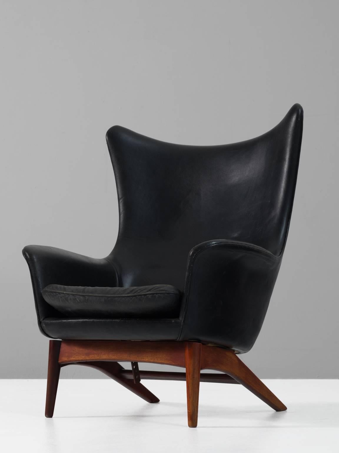 Wingback chair, in teak and leather, by H.W. Klein for Bramin, Denmark, 1950s. 

Sculptural lounge chair by Henry Walter Klein. This wingback chair is a great example of Scandinavian design and comfort. Beautiful organic formed seating, with solid