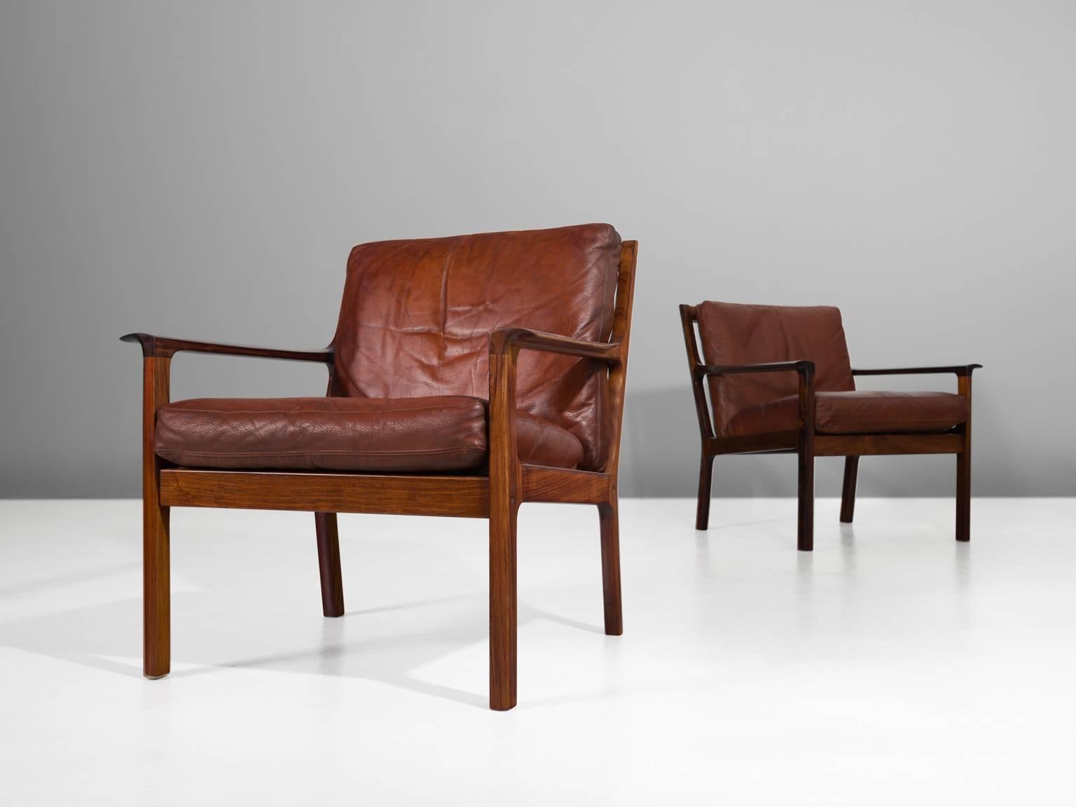 Set of two armchairs, in rosewood and leather, Denmark, 1950s.

A pair of lounge chairs in solid rosewood. These easy chairs have a simplistic design with a very open character. All attention goes to the beautiful and high-quality materials. The