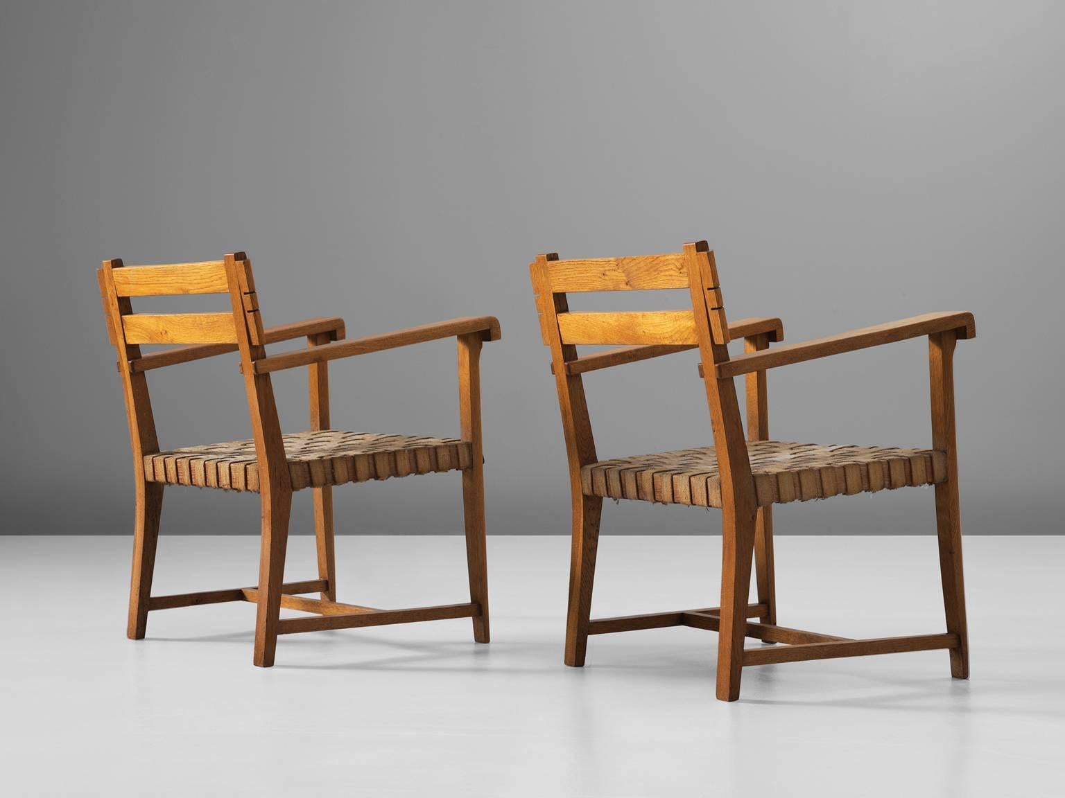 Armchairs, oak and rope, 1940s, France.

These two armchairs in the style of Charles Dudouyt (1885-1946) are both elegant and sturdy in their design. These two chairs might be the perfect pair to stand in a grand entrance or hall way. The roped