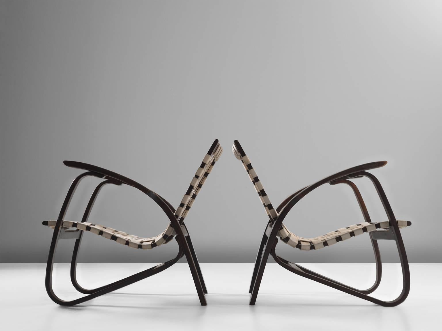 Pair of lounge chairs, in wood and canvas, by Jan Vanek for UP Zavodny, Czech Republic, 1930s.

Stunning pair of dynamic armchairs designed by Czech architect Jan Vanek (1891-1962), who was a contemporary of Jindrich Halabala (1903-1987). These