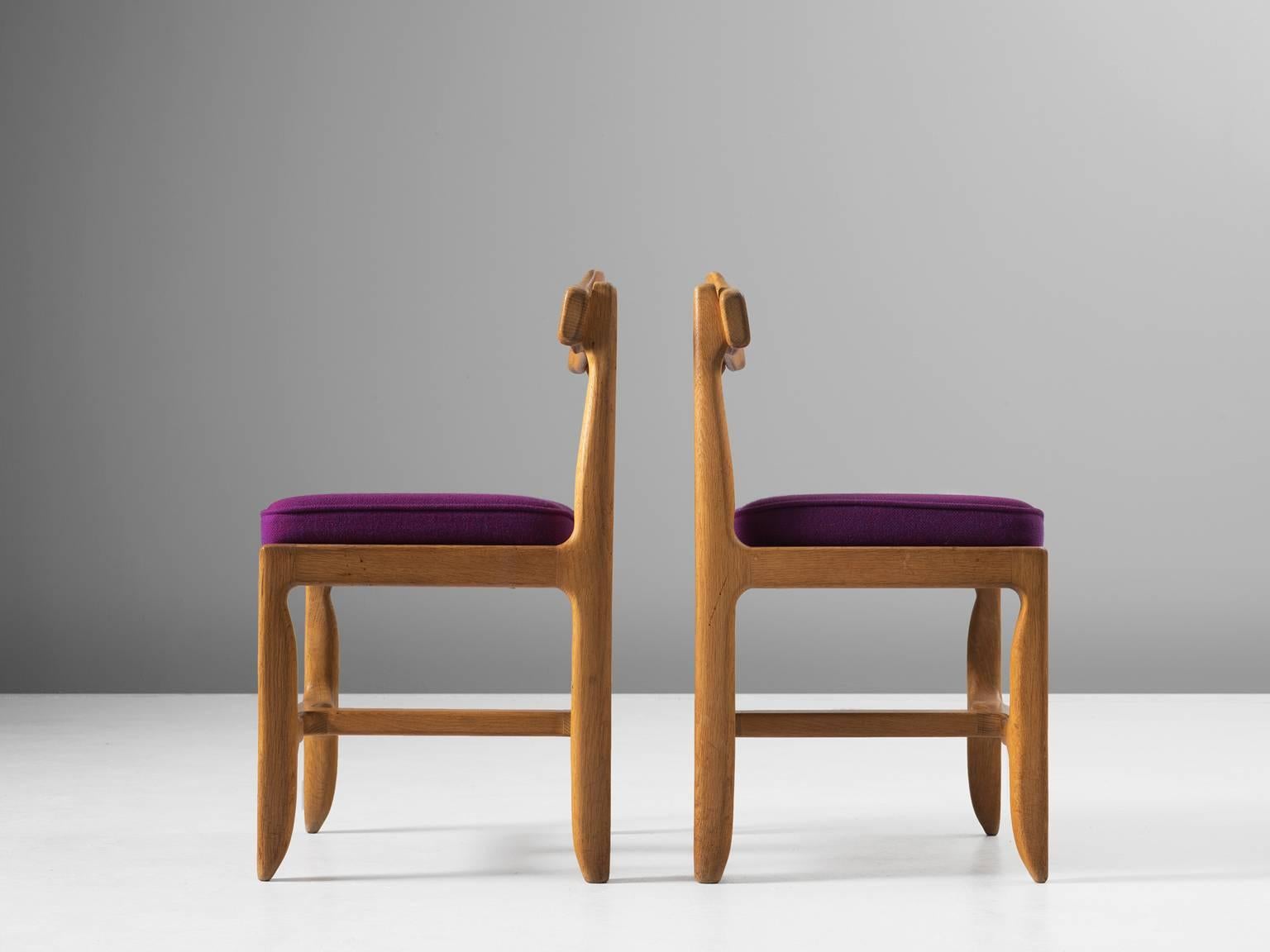 Dining chairs, solid oak, purple upholstery, 1960s.

These distinctive chair in beautifully patinated oak is by the French designer duo Jacques Chambron (1914-2001) and Robert Guillerme (1913-1990). These dining chair shows organic, tender lines