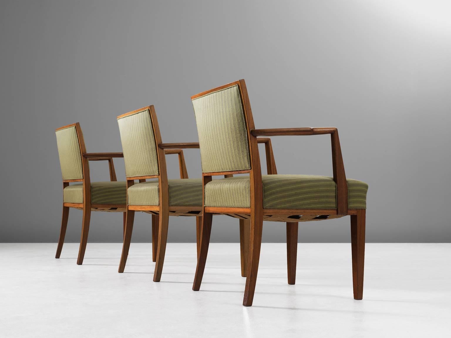 Set of three armchairs, in teak and fabric, Sweden, 1940s. 

Large set of three elegant conference chairs in the style of Hansen Lysberg. These well made armchairs have a beautiful teak wooden frame. The slightly curved armrest is nicely detailed,