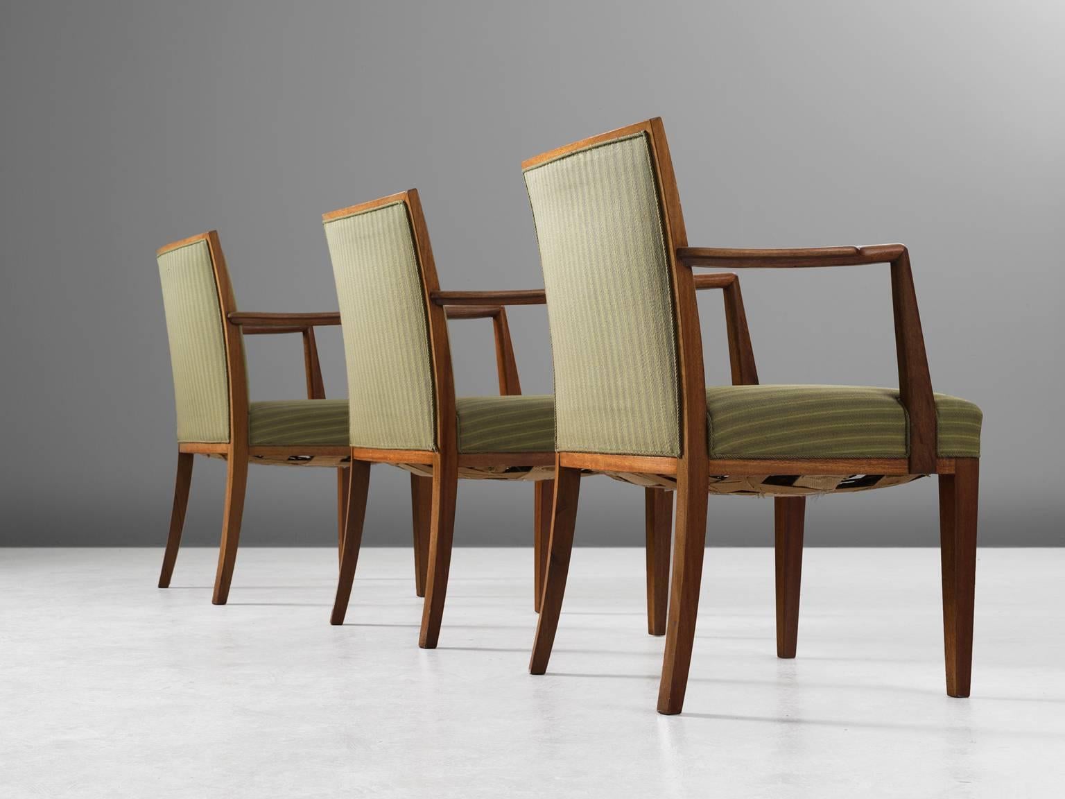 Set of three armchairs, in teak and fabric, Sweden, 1940s. 

Large set of three elegant conference chairs in the style of Hansen Lysberg. These well made armchairs have a beautiful teak wooden frame. The slightly curved armrest is nicely detailed,
