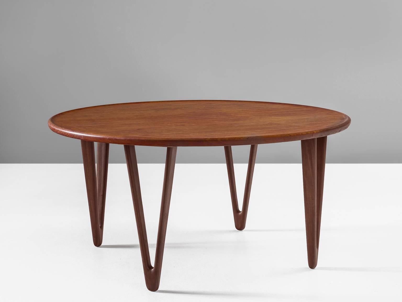 Cocktail table, teak, 1950s, Denmark.

This Danish teak coffee table was designed by Tove Kindt-Larsen (1906-1994) and her husband Edvard Kindt-Larsen (1901-1982) during the 1950s. The table features four hollow triangular teak legs taper towards