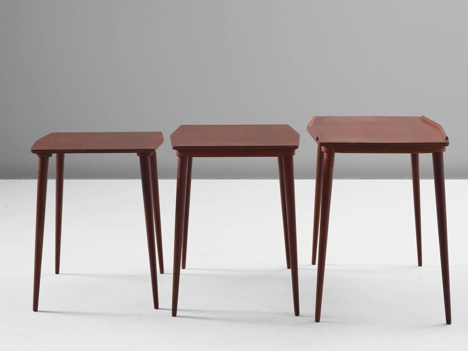 Arne Hovmand-Olsen nesting tables in teak for Mogens Kold, 1960s, Denmark.

This lovely set of three nesting tables is both functional and rich at the same time. The set is lightweight and has beautiful slender tapered legs. The tabletop have small