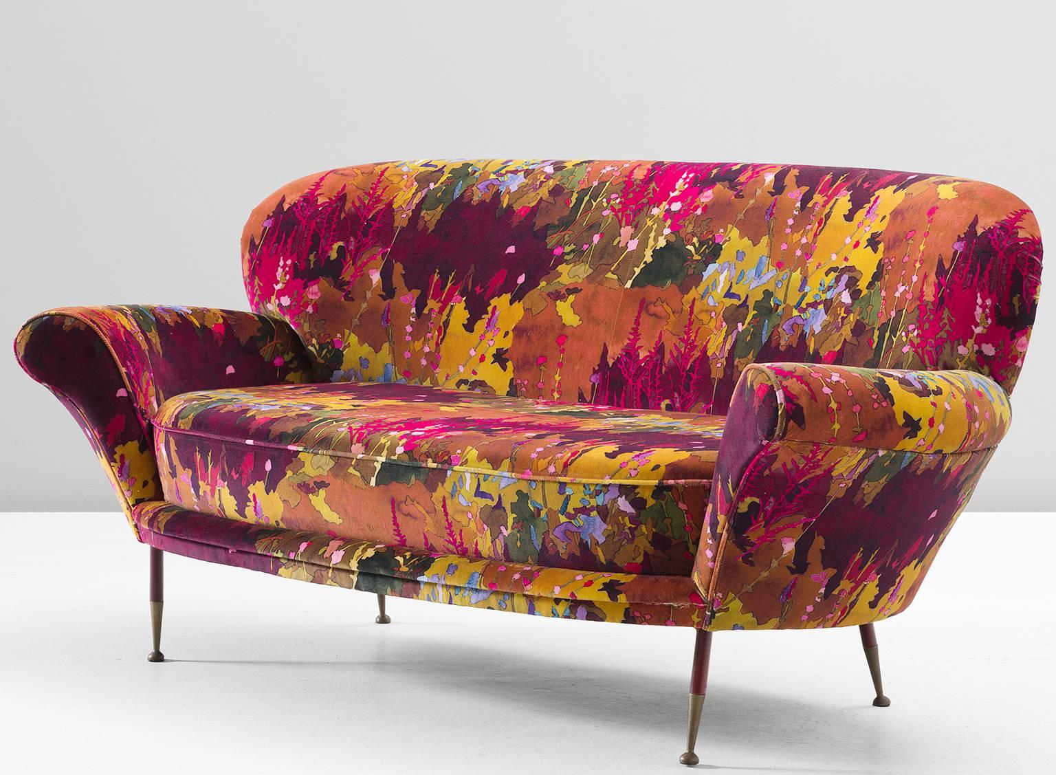 Italian sofa, Pierre Frey fabric and brass, Italy, 1960s. 

This fine voluptuous little sofa is a gorgeous example of Italian design. This comfortable settee relies on its rounded edges and thick cushions. Yet the thin tapering in the arms and