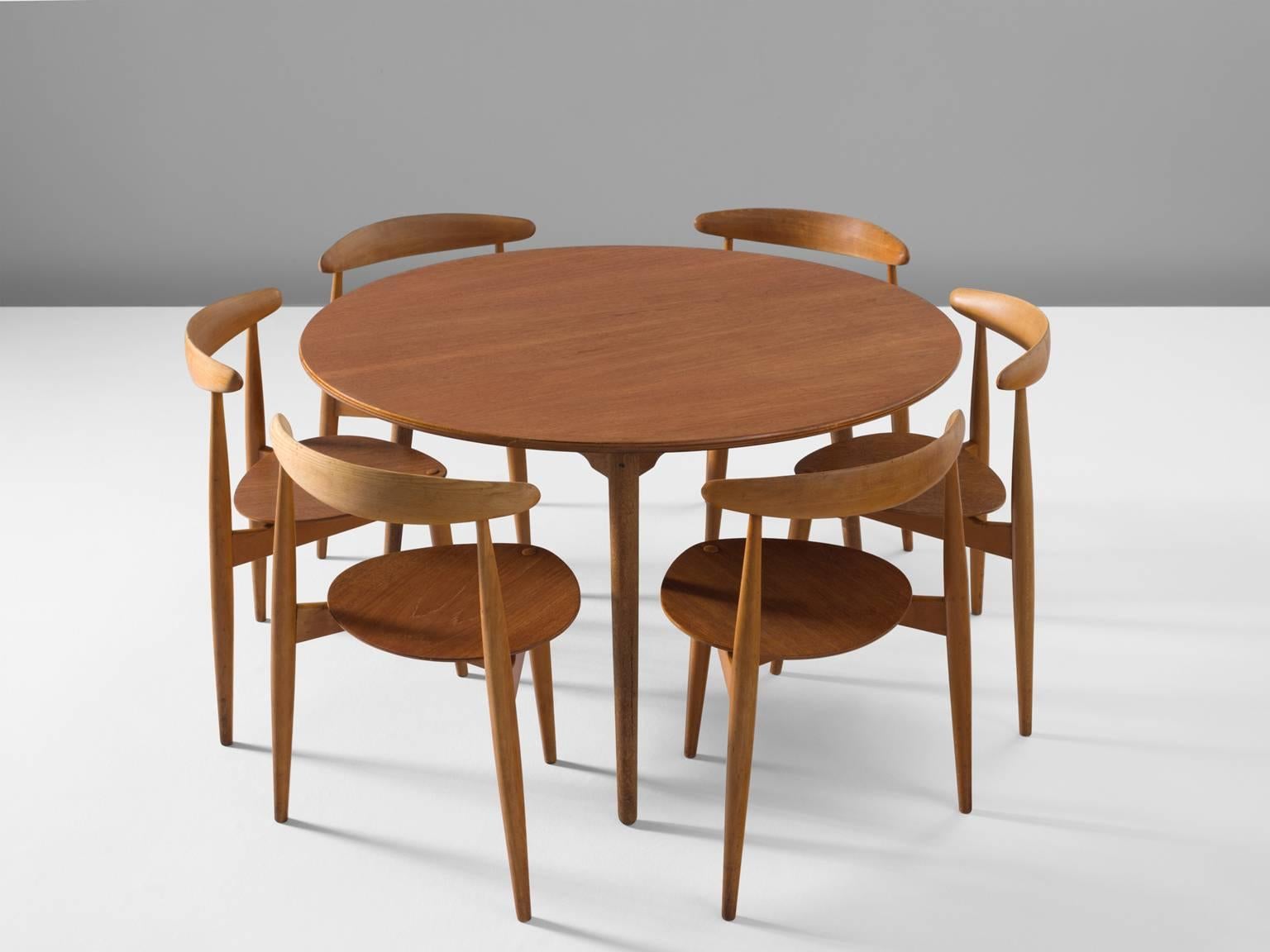 Six heart chairs by Hans Wegner, Denmark, 1953 (original design), 1960s execution.

These armchairs by Hans Wegner are designed to sit flush against a table. The chairs have only three legs, so they can be shoved all the way around a table. This