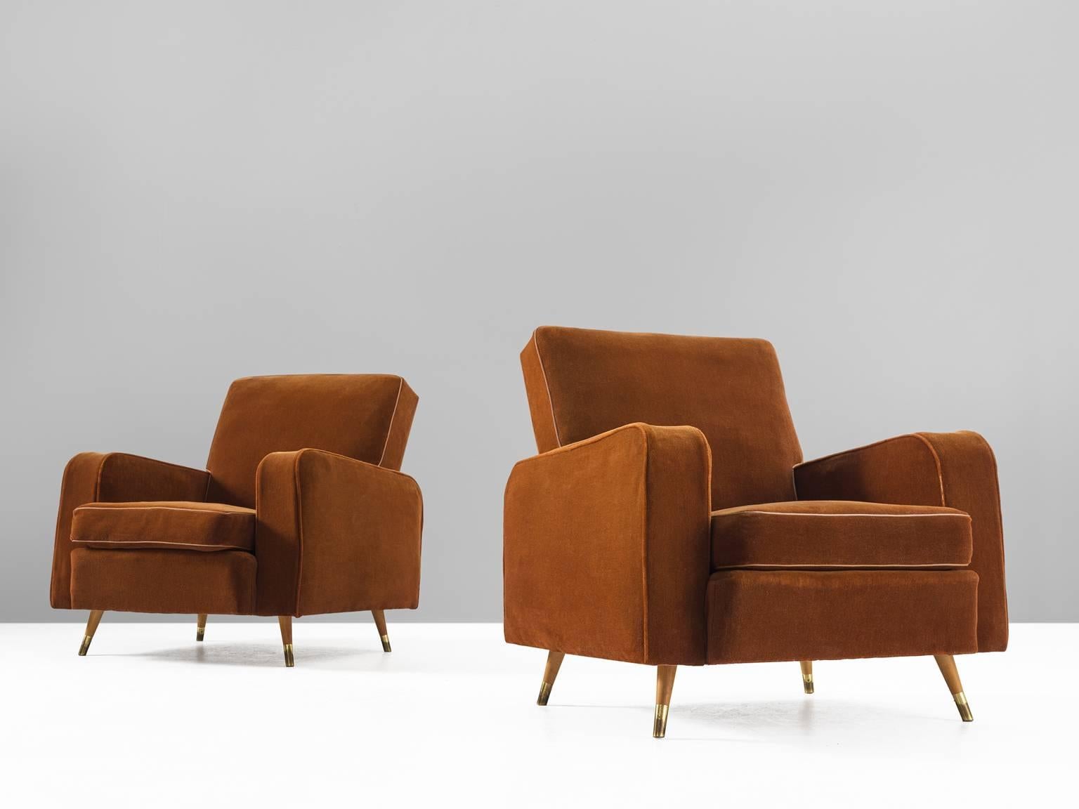 Armchairs, velvet, oak and brass, Italy, 1950s.

This pair of grand comfortable arm chairs are strong and playful at the same time. The back, which is slightly tilted towards the back gives perfect support for the back. The color of these two chairs