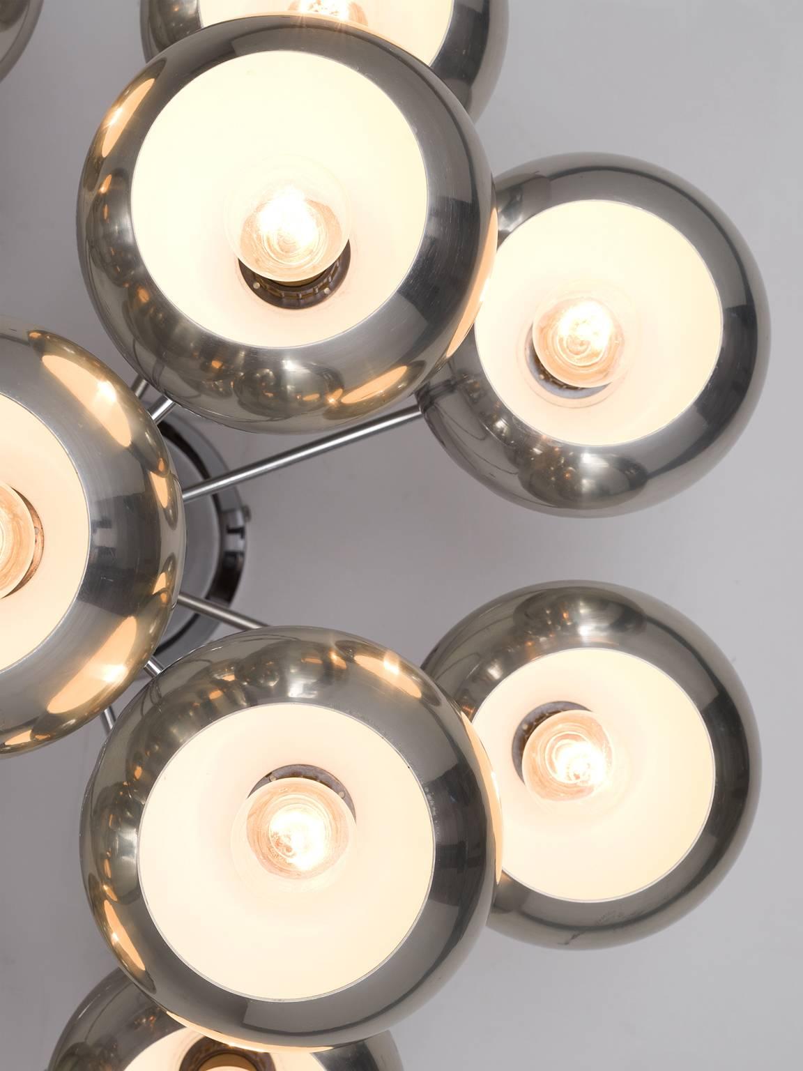 Chrome pendant, Germany, 1970.

This chrome pendant is wonderfully stately and at the same time minimalistic in design. The color of the chrome is muted and light to almost green on the inside. The vertical rod that holds all the chrome balls