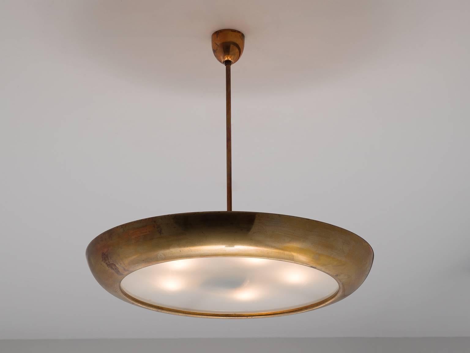 Large pendant, brass, Europe, 1970s.

This very large brass pendant is very sleek and organic at the same time. The lamp is Minimalist in the sense that there is no ornate decoration or additional details. The shade, which is shaped like a disc,