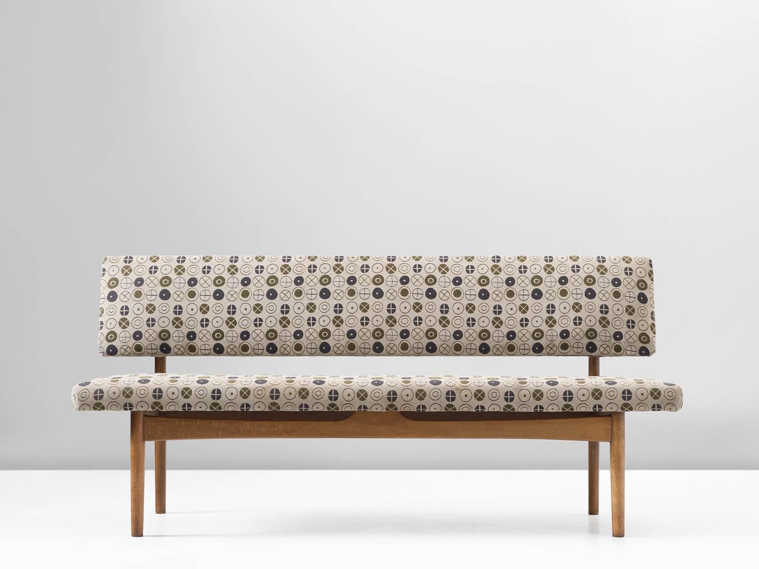 Sofa by Børge Mogensen, fabric and oak, 1960s.

This small sofa from the 1960s is upholstered with the iconic fabric Circles 002 Fatigue designed by Charles & Ray Eames for Maharam in 1947. This abstract, patterned fabric is a suiting fit for the