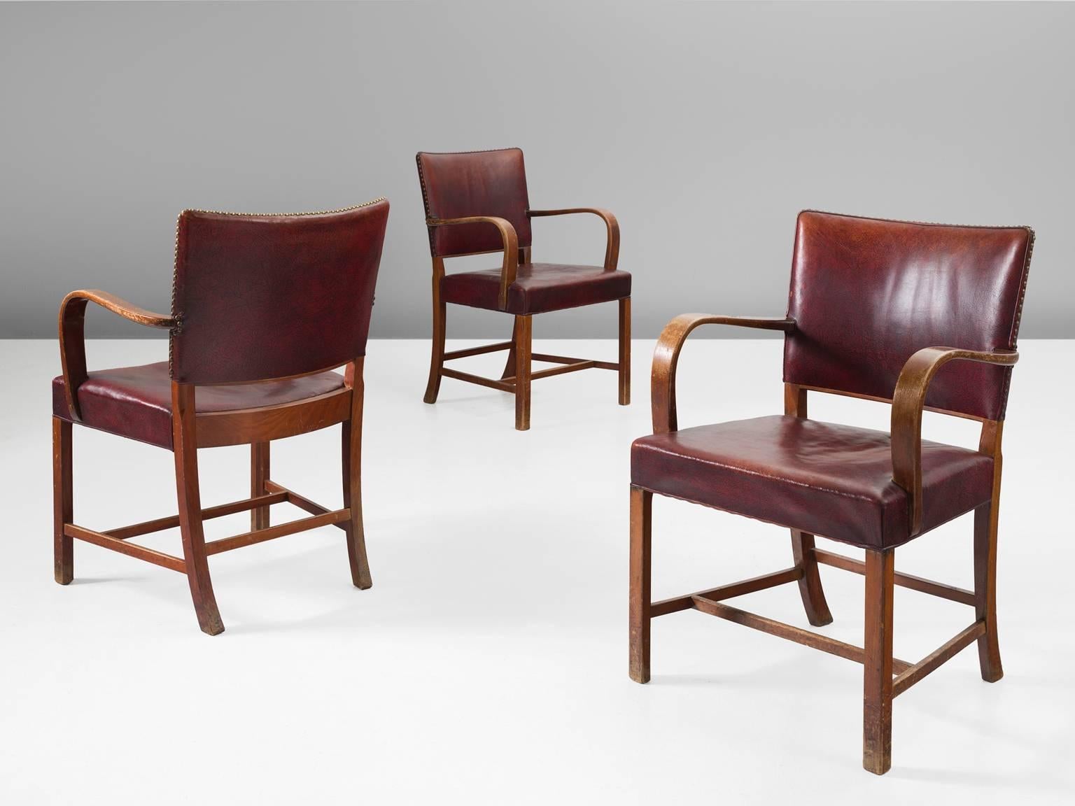 Fritz Hansen, dining chairs, beech and red leather, Denmark, 1940s.

These chairs are strong and sturdy. They seem almost proud about their appearance. These chairs once served on board of the ship Aegir. The combination of the material, the top