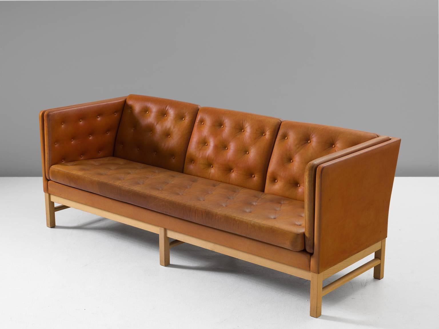 Sofa model EJ 315-3, wood and leather, by Erik Ole Jørgensen for Erik Jorgensen Møbelfabrik, Denmark, 1972. 

Elegant three-seat sofa by Erik Ole Jørgensen. This sofa has a luxurious appearance due to the tufted cognac leather. The orderly placed