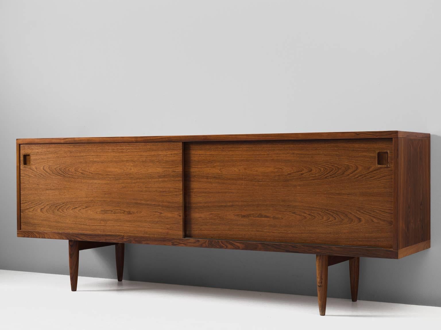 Credenza, rosewood, by J.L Møllers Møbelfabrik, Denmark, 1960s.

This lovely medium-sized sideboard is a Classic example of the craftsmanship of Danish midmodern design. At the same time, it Stand for the Scandinavian postwar vision of practical
