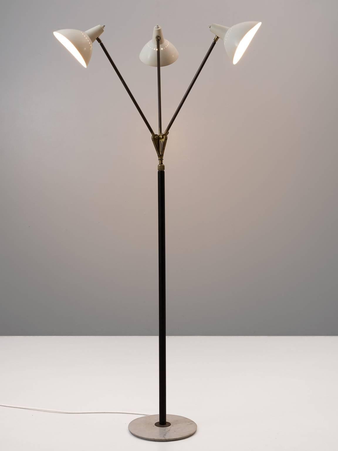 Floor lamp, in brass, metal and marble, for Stilnovo, Italy, 1950s.

Stunning floor lamp with three white coated shades in all directions and can be switched of separately. Each shade is supported by a brass stern, which combine into one black