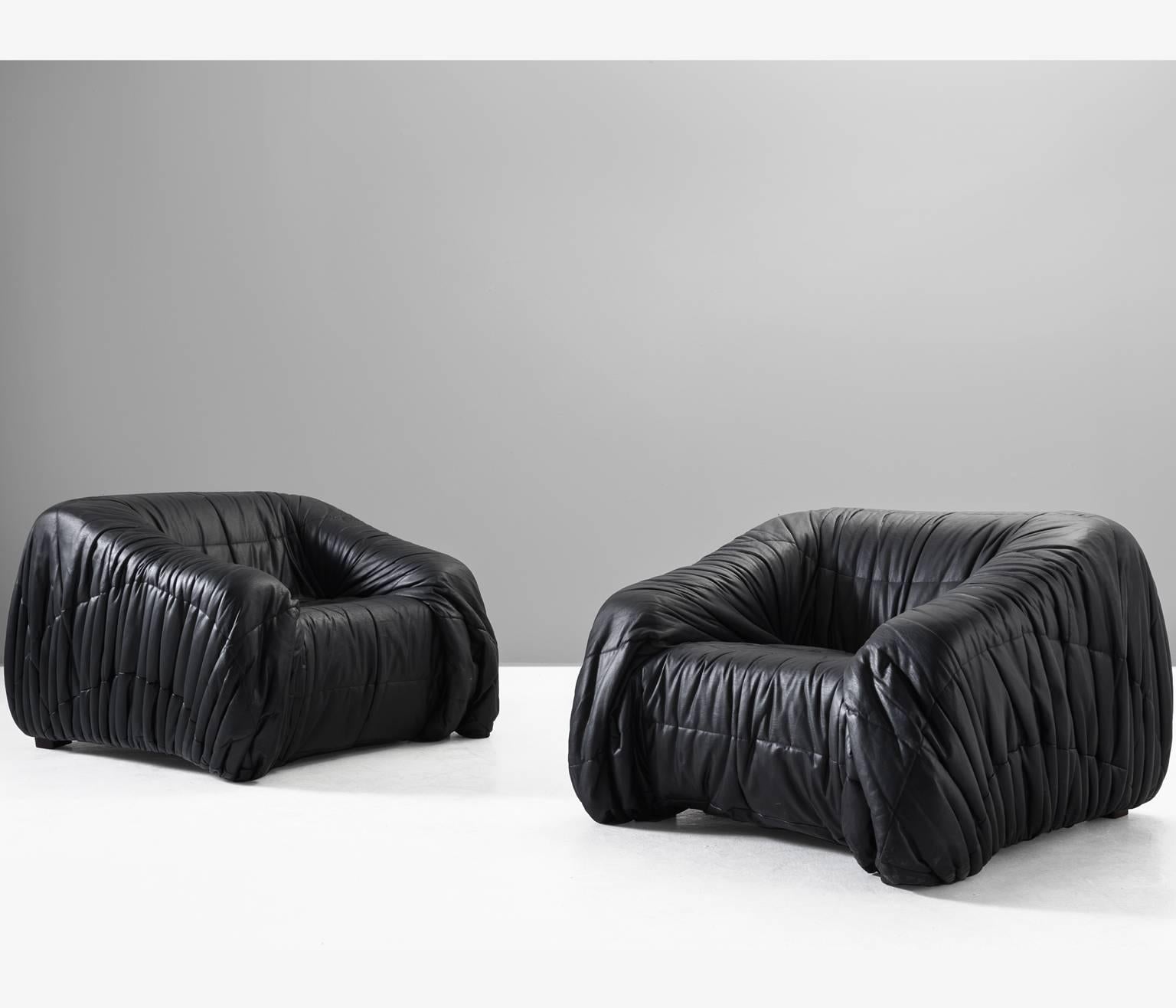 'Piumino' lounge chairs by Jonathan de Pas, Donato D'urbino & Paolo Lomazzi for Dell'Oca, Italy, 1970. 

These lounge chairs are completely moulded out of foam and covered with folded black, thick butter-soft leather. One of the mean traits of these