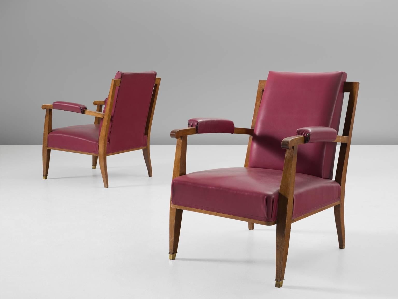 Pair of armchairs by Jules Leleu, in Italian walnut and skai, France, 1957.

This set of playful chairs are made out of solid oak and thick cushion upholstered with red to pink skai leather. The detailing is interesting in both the armrests and