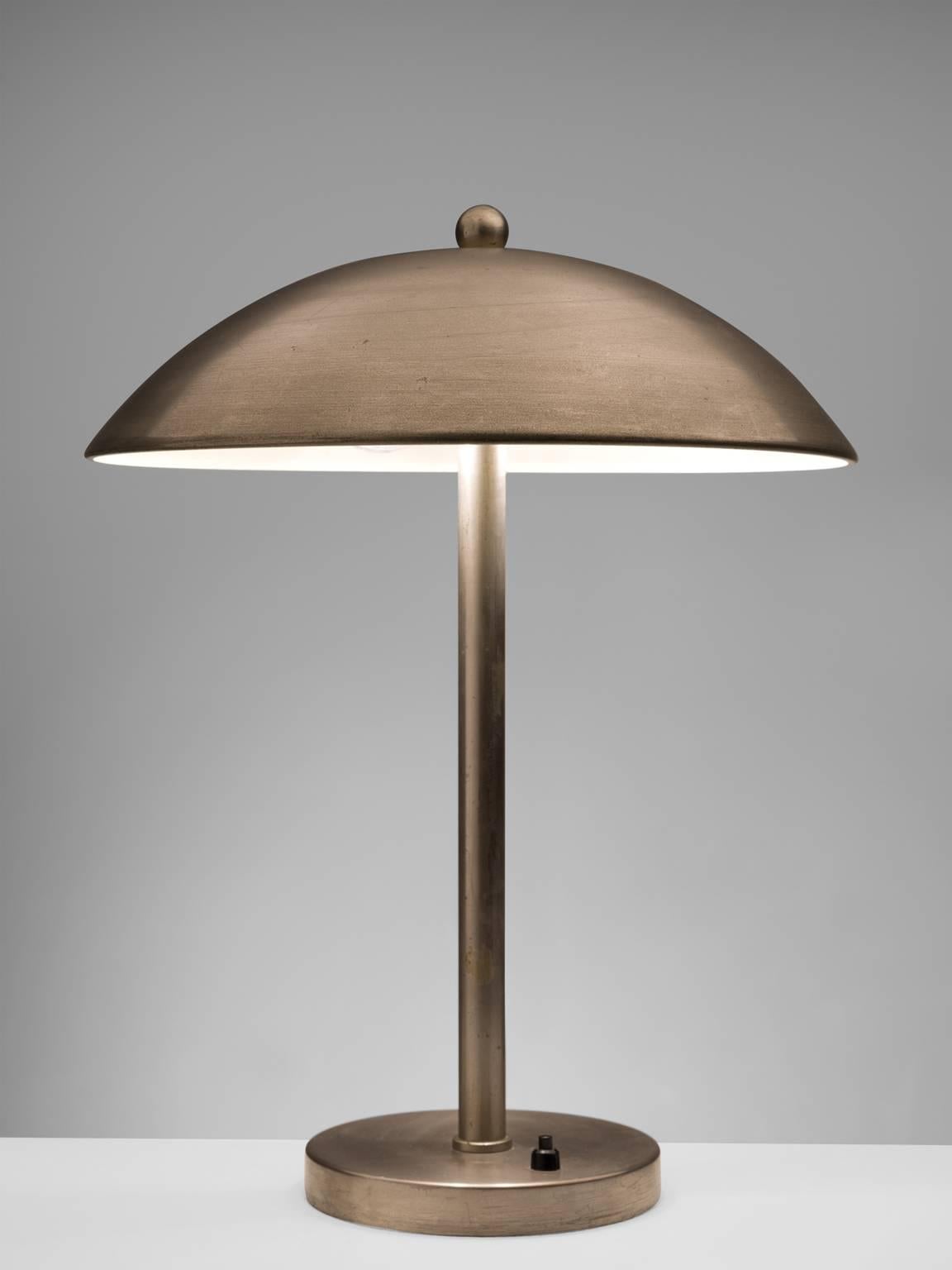 Table lamp, nickel, Europe, 1970s.

This desk lamp made out of nickel is functional and elegant at the same time. The rounded shade combined with the straight pole and small base resemble the classic shape of art deco, 1930s desk lamps. The light