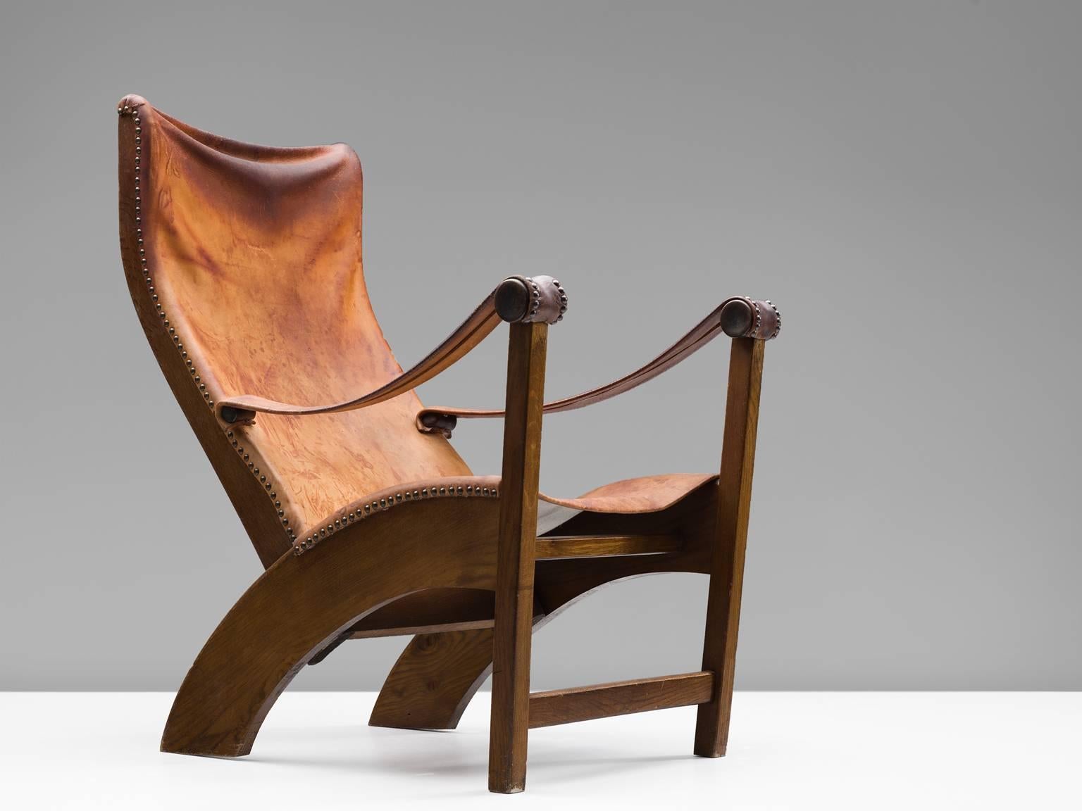 Lounge chair model 'Københavnerstolen', in oak and leather, by Mogens Voltelen for cabinetmaker Niels Vodder, Denmark, 1936. 

Stunning Copenhagen lounge chair by Mogens Voltelen (1908-1995). Early and rare variant in which the armrest is attached