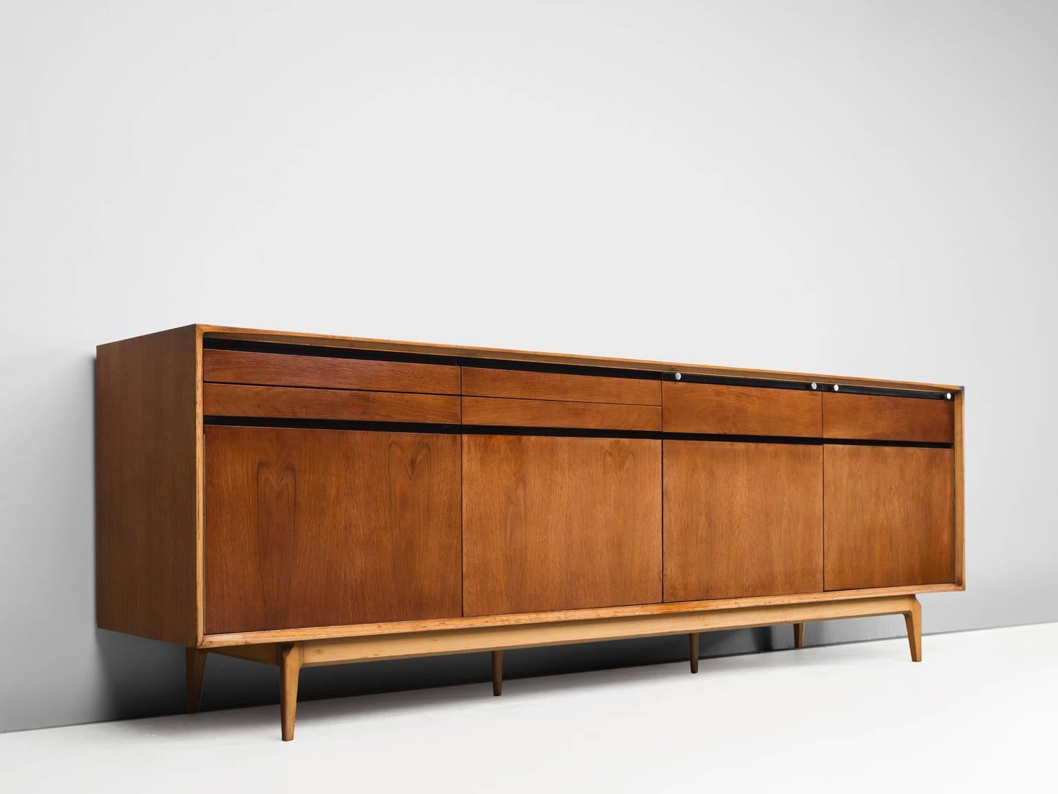 Sideboard, rosewood and walnut by De Coene, Belgium, 1958.

This sideboard is well-constructed and detailed in a discrete manner. Produced in rosewood and walnut. The piece shows well-designed lines and interesting details, such as the folding