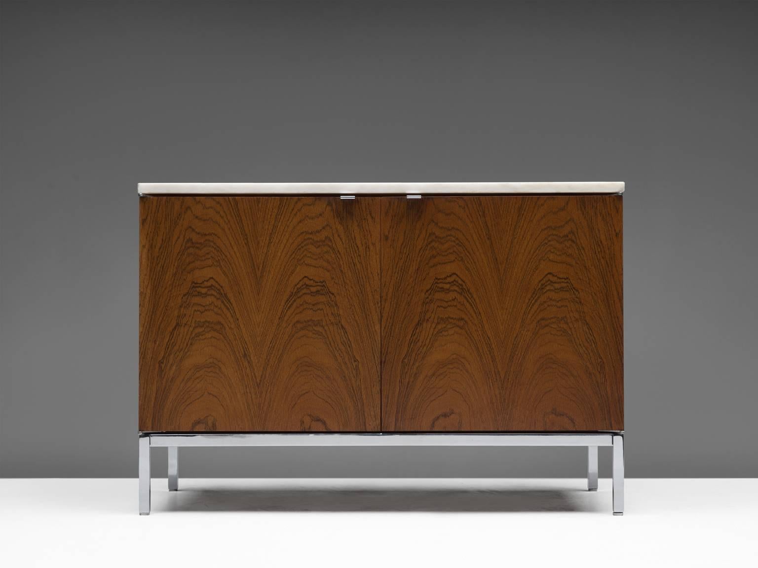 Sideboard, in rosewood, marble and metal by Florence Knoll for Knoll International, United States, 1961. 

This small credenza with chromed base is designed by Florence Knoll for Knoll International. This minimalistic designed credenza has