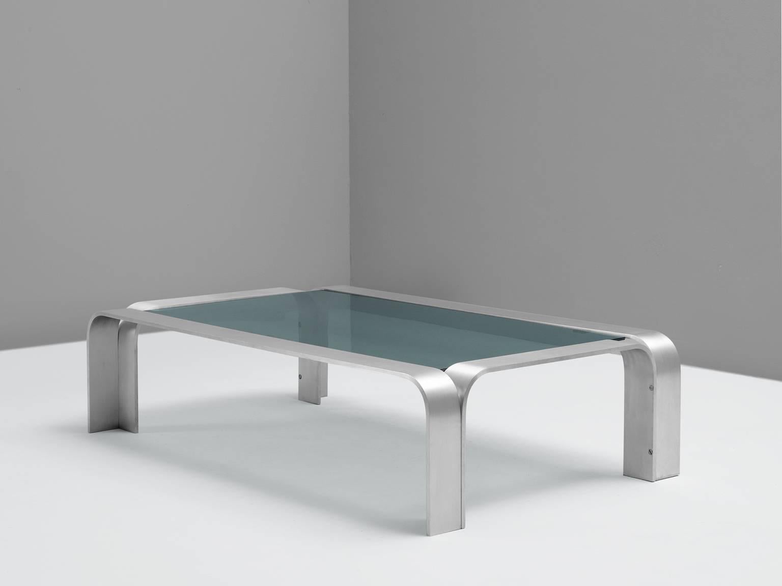 Coffee table, aluminium and glass, European, 1970s. 

Modernist coffee table. The rectangular table is accompanied by a dark glass top. The aluminium frame consist of four bended arches. The frame is manufactured from metal strips and rounded edges.