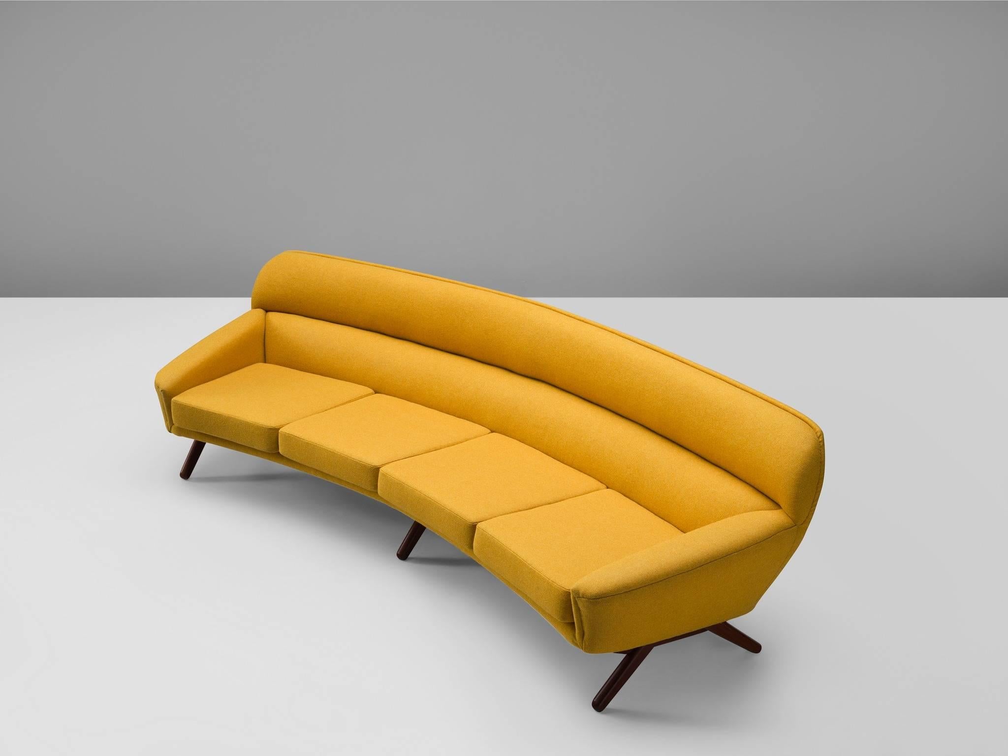 Danish sofa in yellow upholstery and teak, designed by Leif Hansen, Denmark, 1960s. 

This curved sofa is designed to provide an ultimate level of comfort. The slightly curved and tilted back, the thick foam and high-quality fabric make this sofa