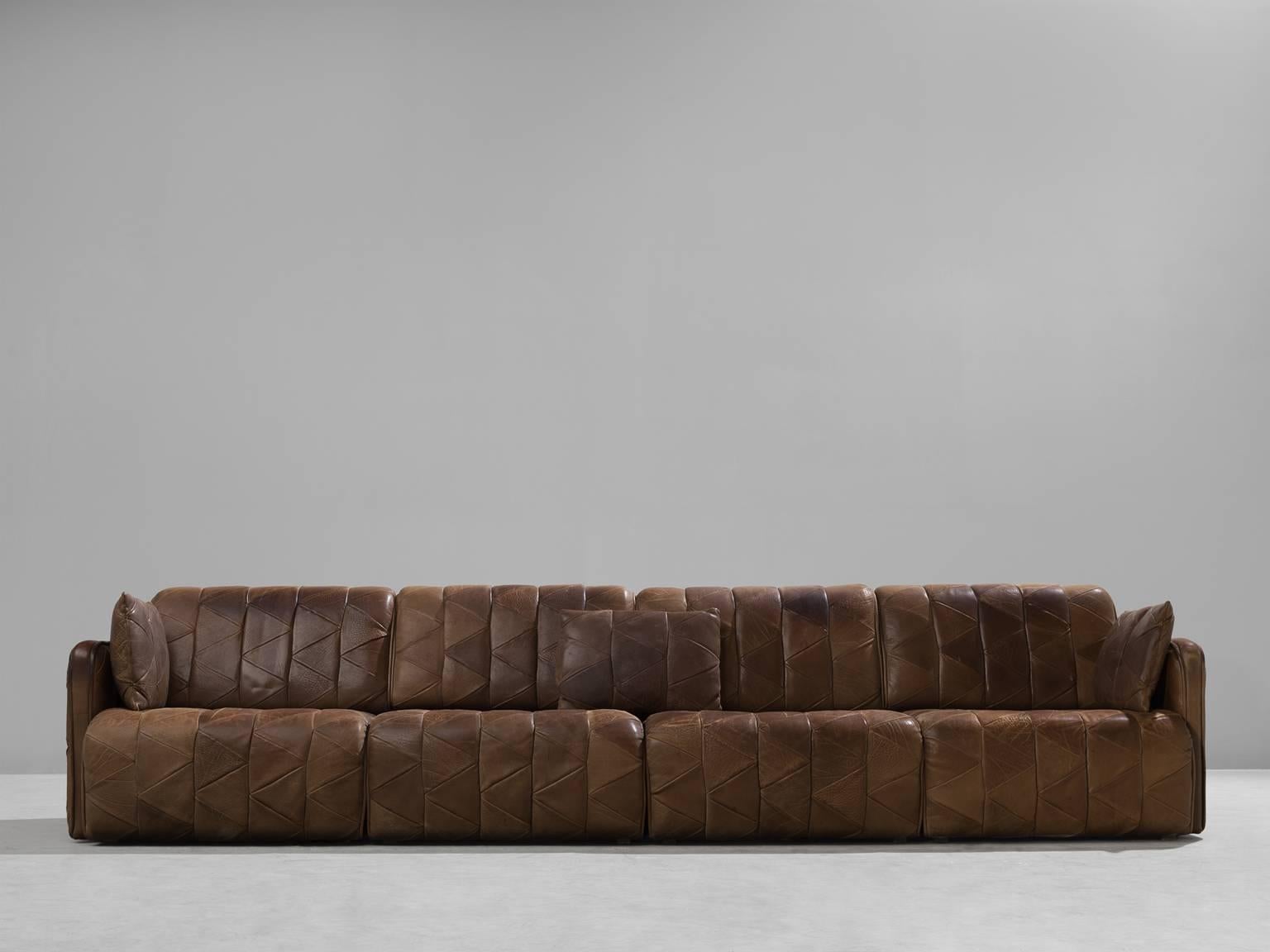 Sofa, brown DS11, patinated leather, 1970s. 

This comfortable leather sofa is manufactured by De Sede in Switzerland. Sectional sofa by the Swiss quality manufacturer De Sede. This sofa consists of four elements with backrest and is extendable in