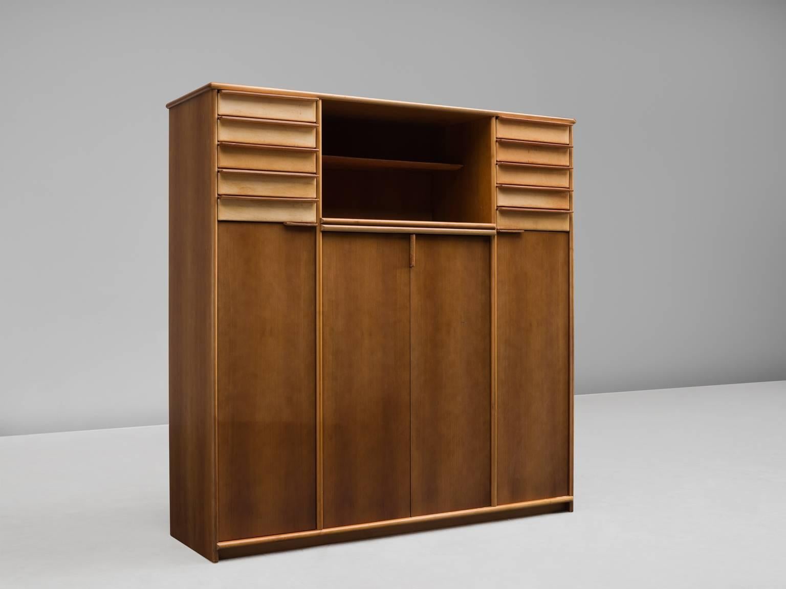 Cabinet, leather, walnut, Italy, 1950s.

This extremely well-executed cabinet is made out of walnut and cognac leather. It It features four doors, three shelves and fives drawers on each side of the cabinet. In the middle between the two units of
