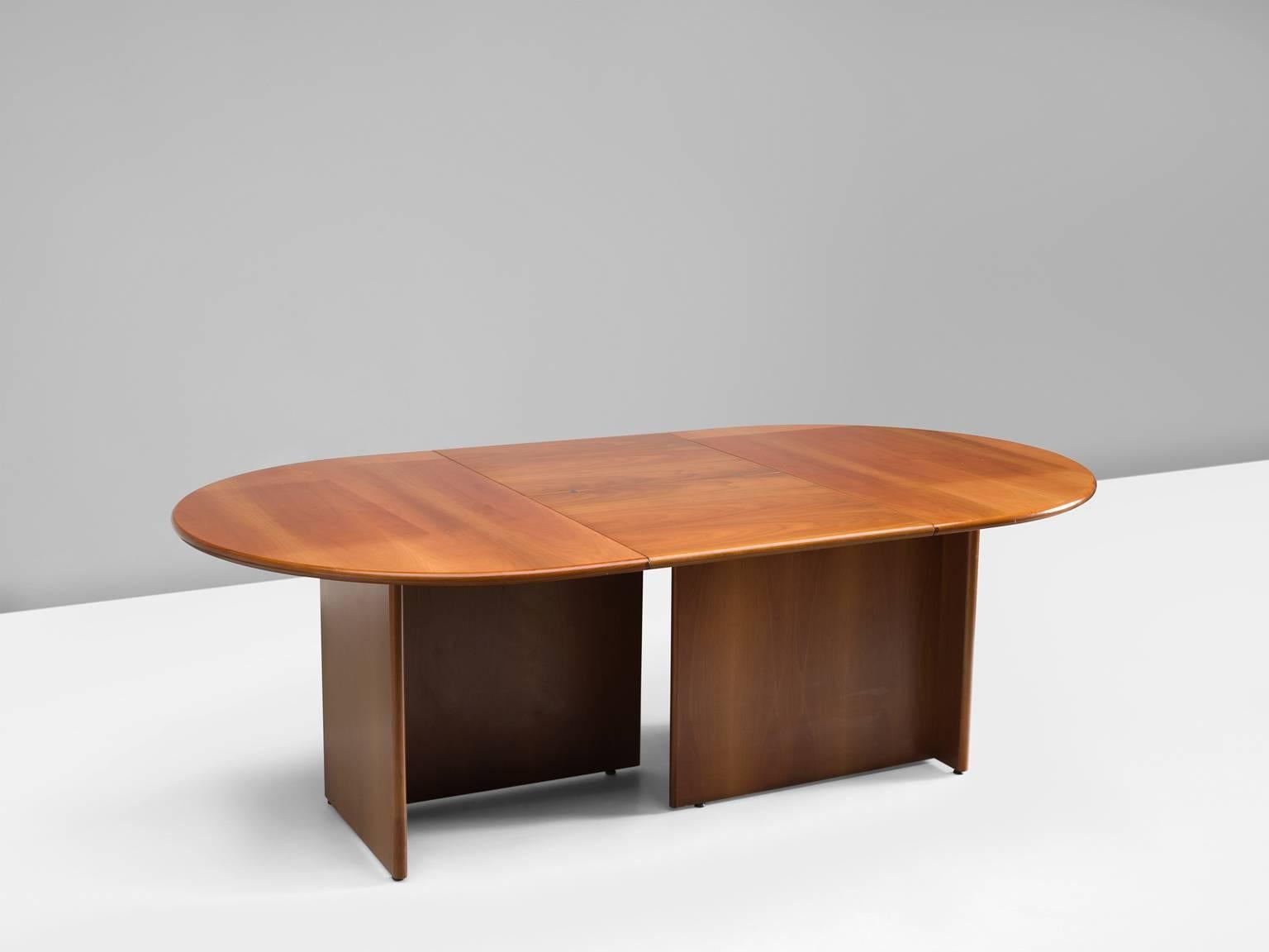 Dining table, walnut, Italy, 1950s.

This table is executed in Italian walnut. The top is oval whereas the base exists of two separate angles that together form an open rectangle. These angles can be put together and the top can be made smaller,