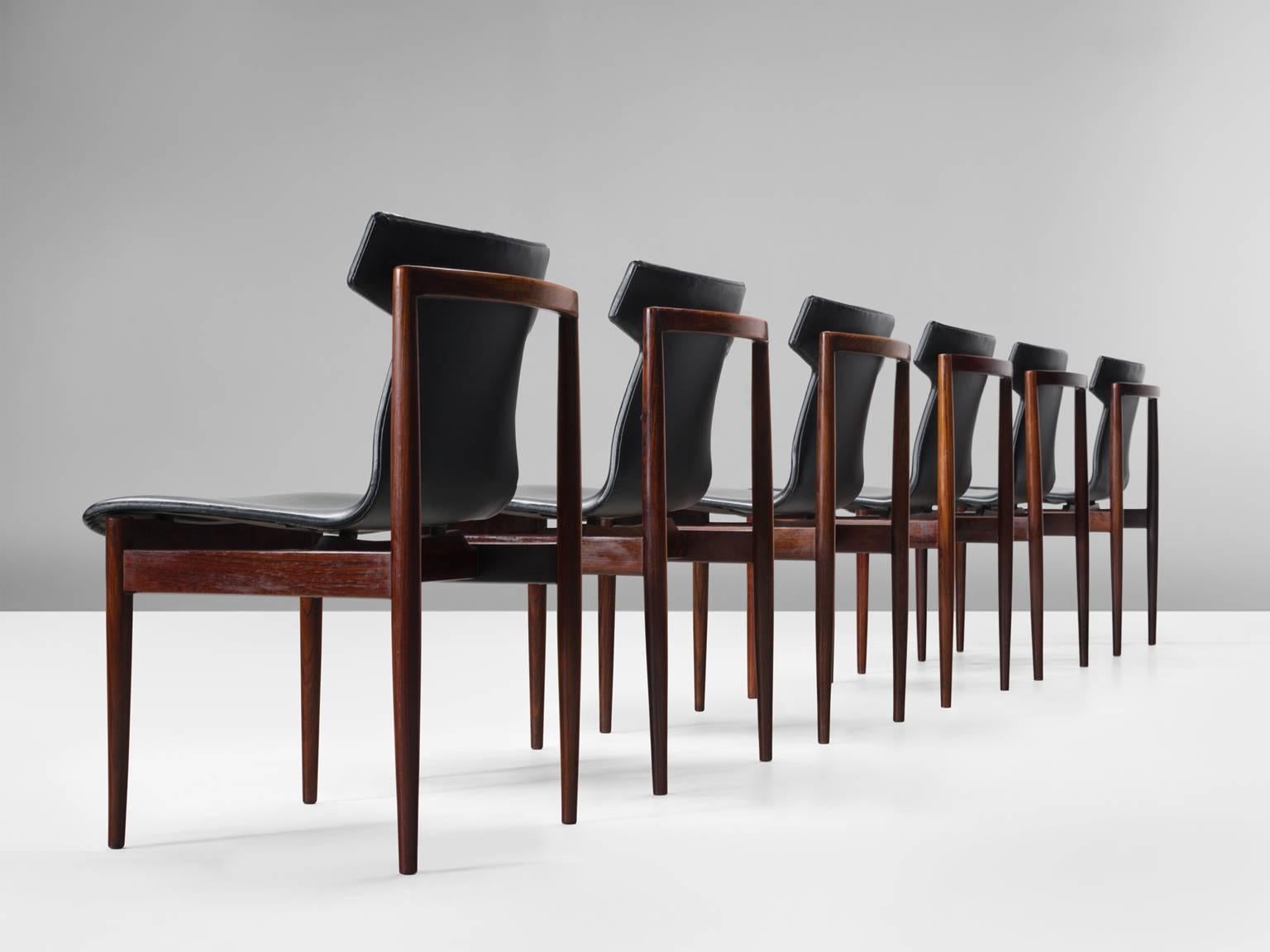 Set of six chairs model 'IK', in rosewood and faux-leather, by Inger Klingenberg for Fristho, Netherlands, 1960.

Set of six rosewood chairs with sculptural seat which is executed in black faux-leather seating. The solid, straight rosewood frame