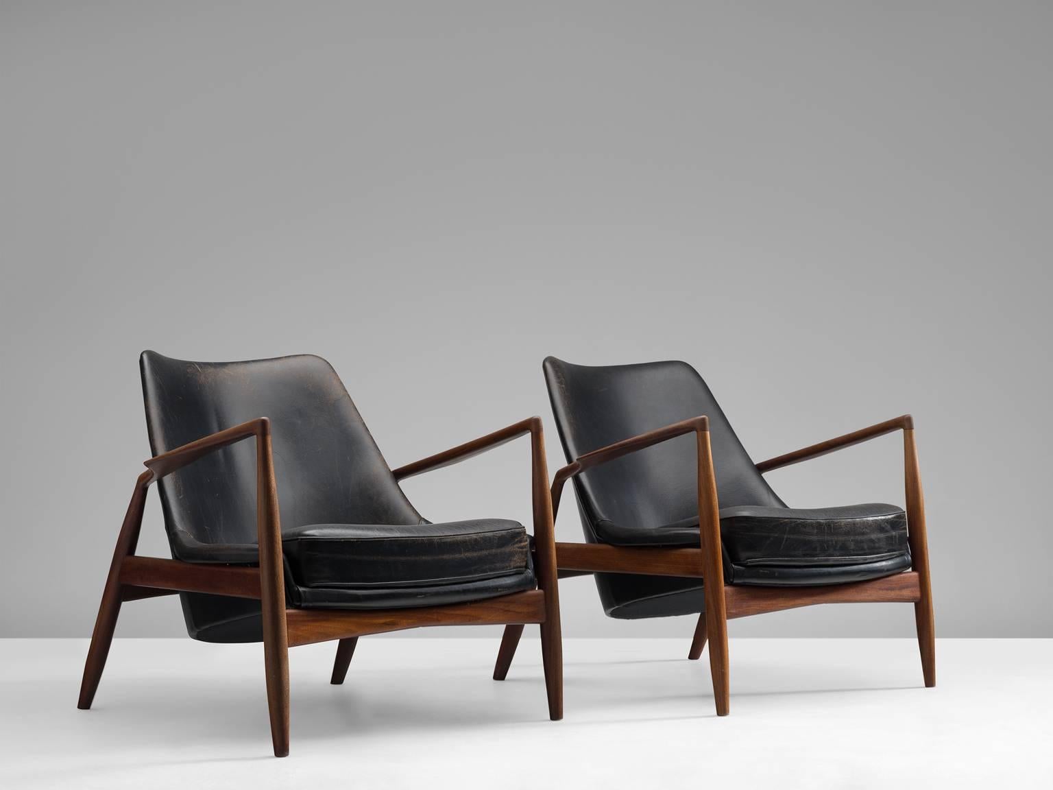 Set of two 'Seal' lounge chairs model 503-799, in teak and leather, by Ib Kofod-Larsen for OPE, Sweden, 1956. 

Beautiful and iconic seal lounge chairs. The well-crafted frame of this chair is made of a dark colored teak. It shows very nice