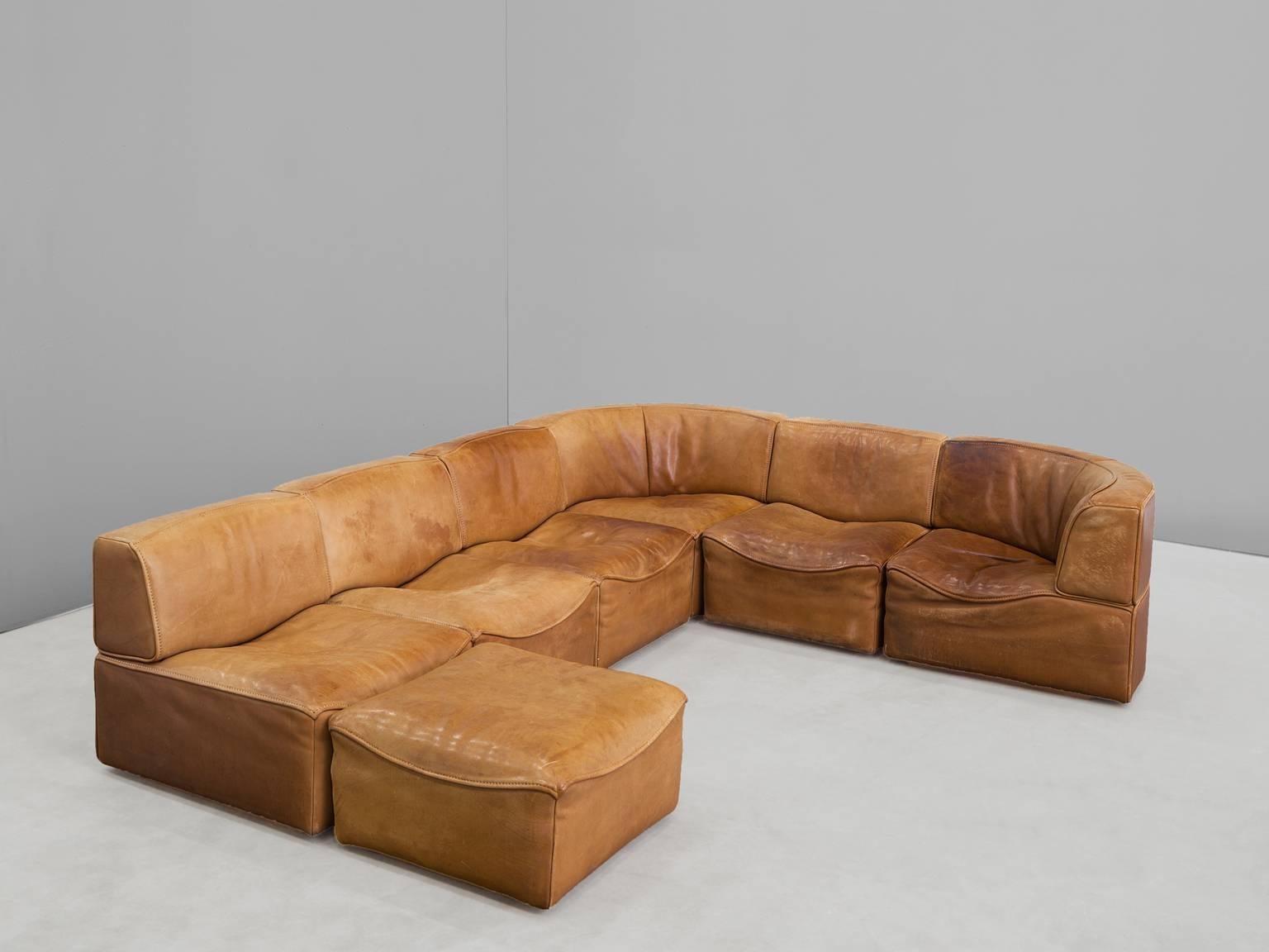 Sectional sofa model DS-15, in cognac leather by De Sede, Switzerland, 1970s. 

This sectional sofa contains two corner elements, four normal elements and an ottoman making this a seven elements sofa. The section makes it possible to arrange this