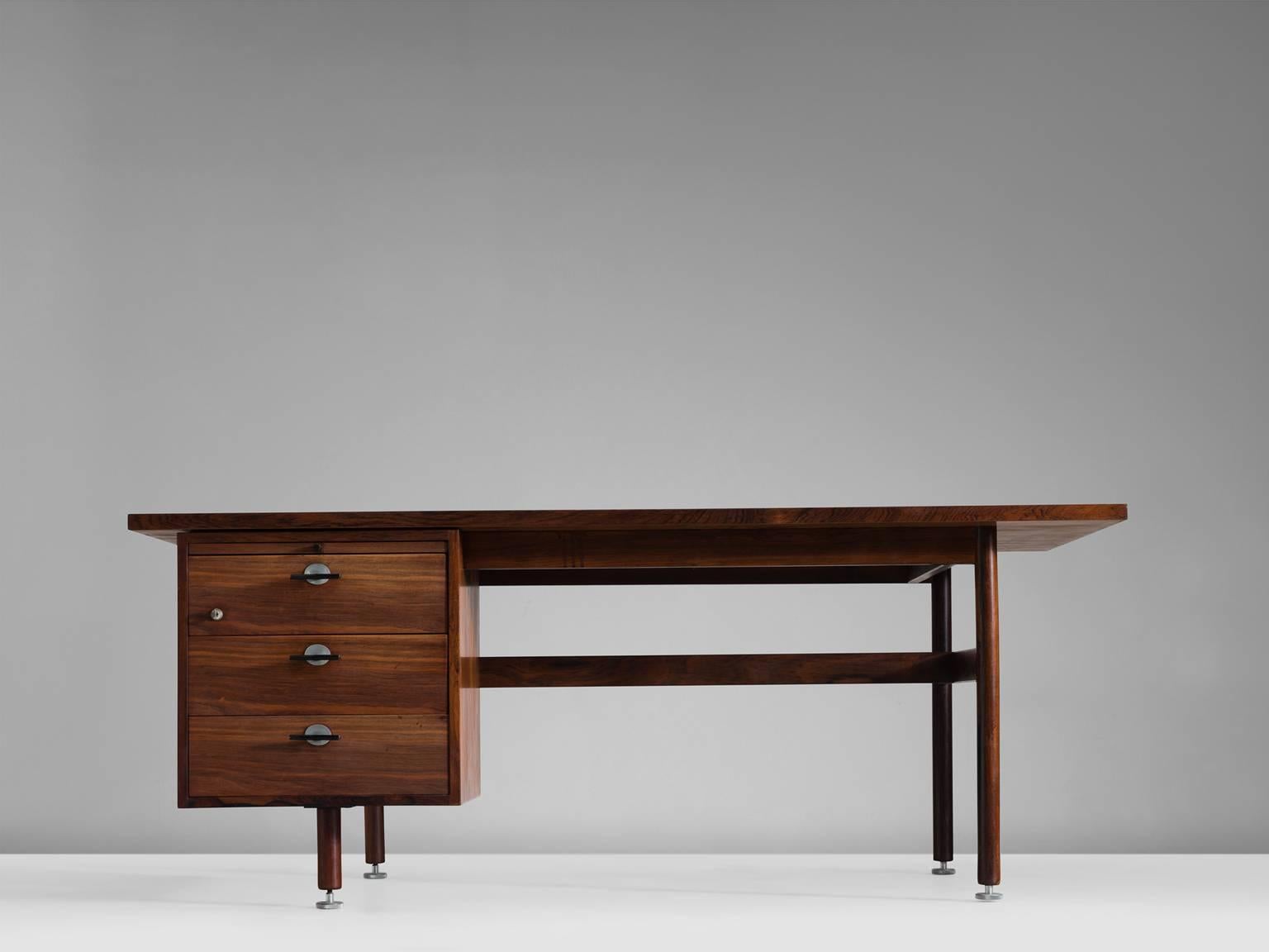 Executive desk in rosewood, by Jens Risom, Denmark, 1960s.

This well designed desk has three drawers on the left side, with nice black metal handles. The rectangular top has a nice rosewood grain, as well as the drawer fronts and legs.

The