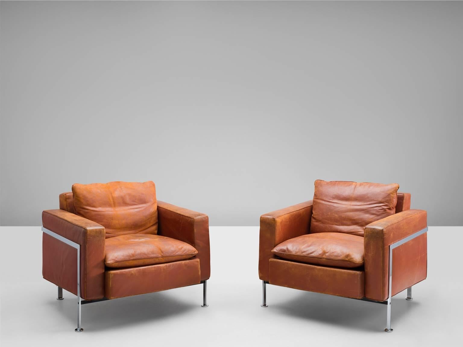 Pair of cognac leather armchairs by Robert Hausmann, for DeSede, Switzerland,  1954.

This rare model shows the extreme high quality this exclusive brand is famous for. These lounge chairs have absolute great comfort, due to the well designed