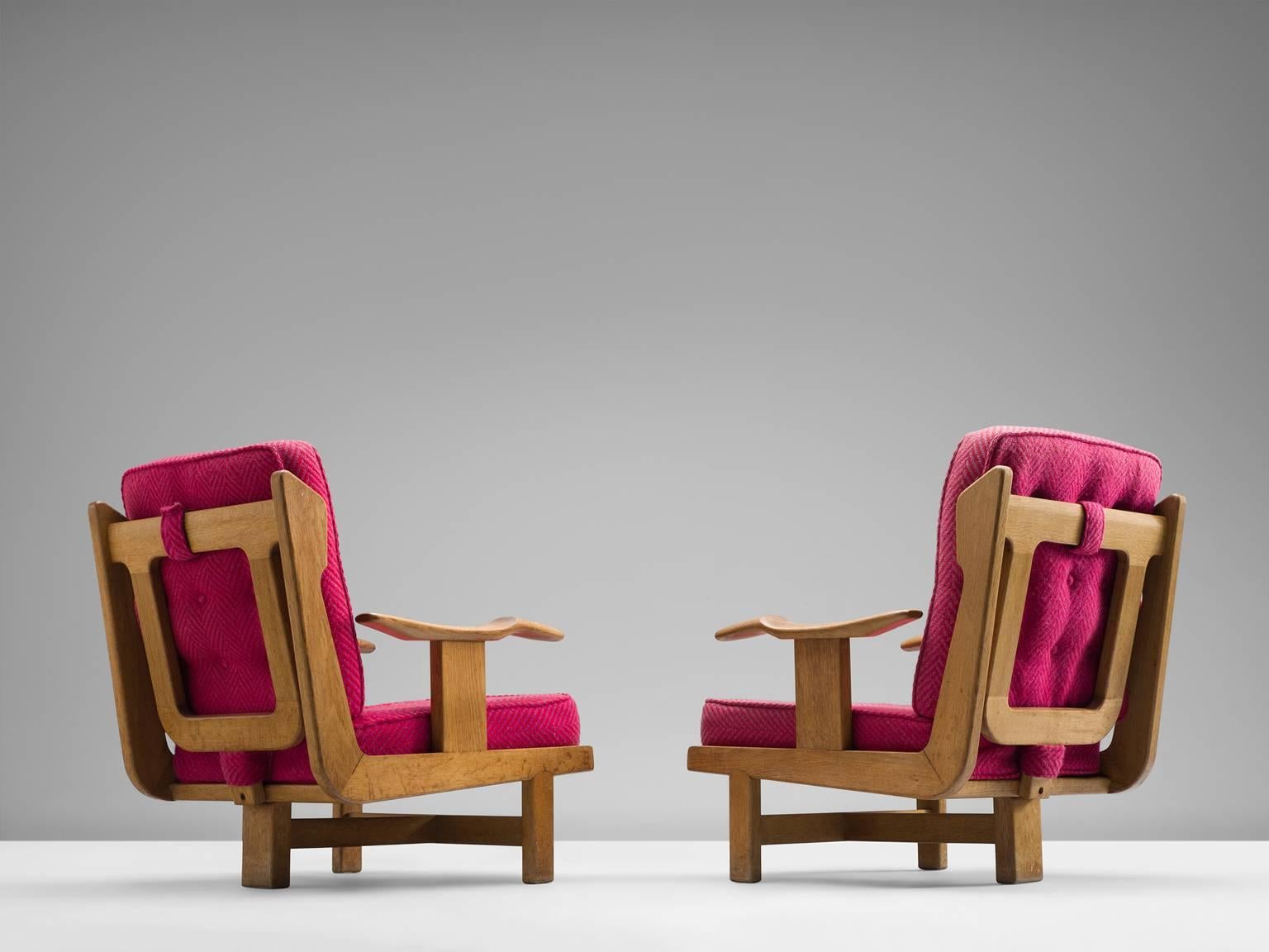 Pair of two tripod lounge chairs in solid oak and pink fabric, designed and crafted by Guillerme & Chambron, France 1960s.

This particular model is quite rare, it shows the wonderful craftsmanship Guillerme & Chambron are well known for.
The