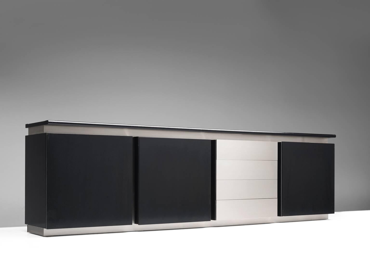 Credenza, oak and steel, 1970s, Italy.

Sleek and modern credenza in stainless steel and stained oak. This cabinet has both a contemporary yet monumental appearance. The design is simplistic and straight. The vertical lines alternate with