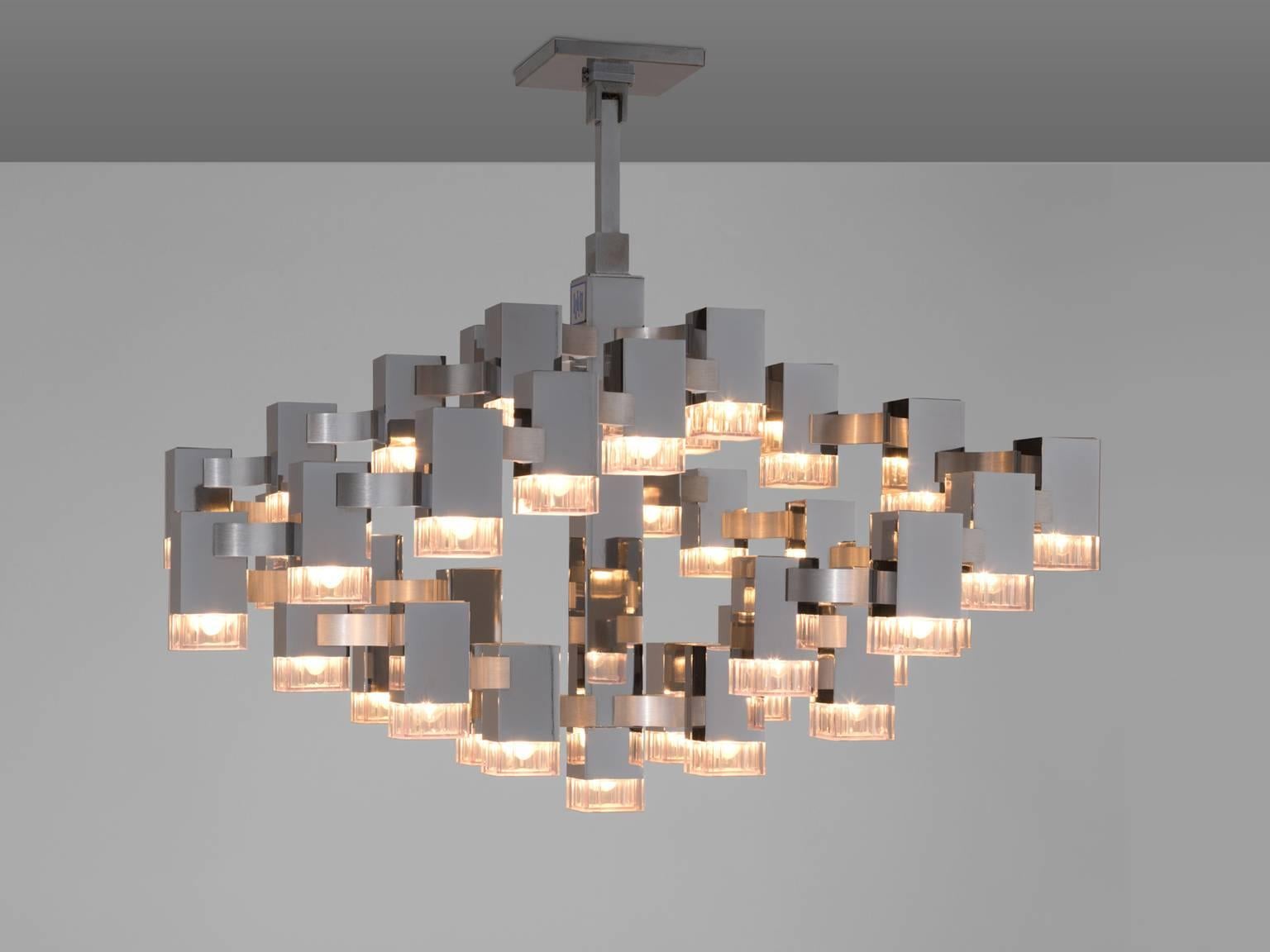 Chromed chandelier by Gaetano Scriolari, Italy, 1970s.

Stunning chromed chandelier with a stunning light-partition. The chandelier is divided into a raster. All lights are connected by means of tubular crosses, which together form a beautiful