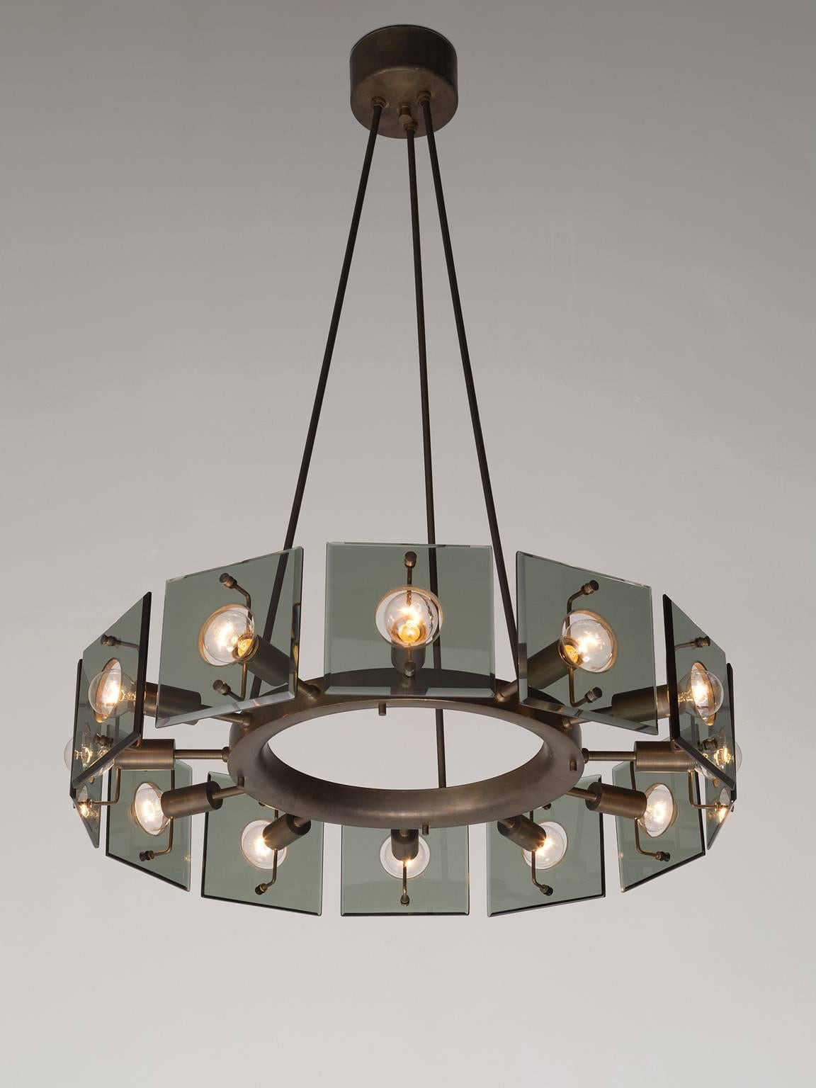 Stunning round chandelier in glass, metal and brass in the style of Max Ingrand for Fontana Arte, 1950s

Unique round chandelier. The fixture is made of three brass stems, which run into a round shaped shade with 12 light points that are covered