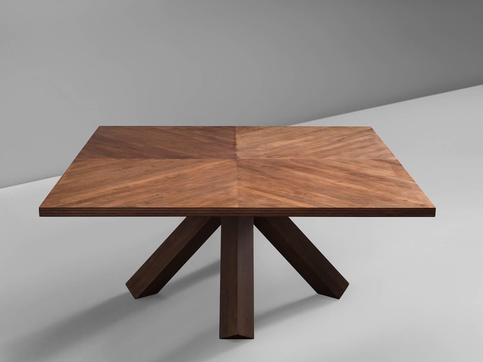 Dining table, wood, Mario Bellini for Cassina, Italy, 1976.

This solemn, architectural coffee table features a hefty, sturdy tripod base and a table that consists of four square elements with several planks. This table is designed by Bellini as