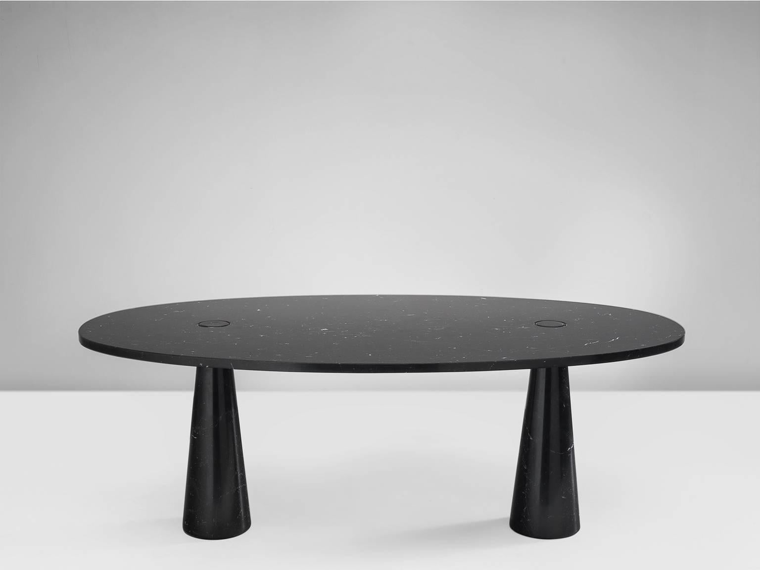 Dining table by Angelo Mangiarotti, marble, 1970s. 

This sculptural table by Angelo Mangiarotti is a skillful example of postmodern design. The table is executed in nero marquina marble. The oval table features no joints or clamps and is