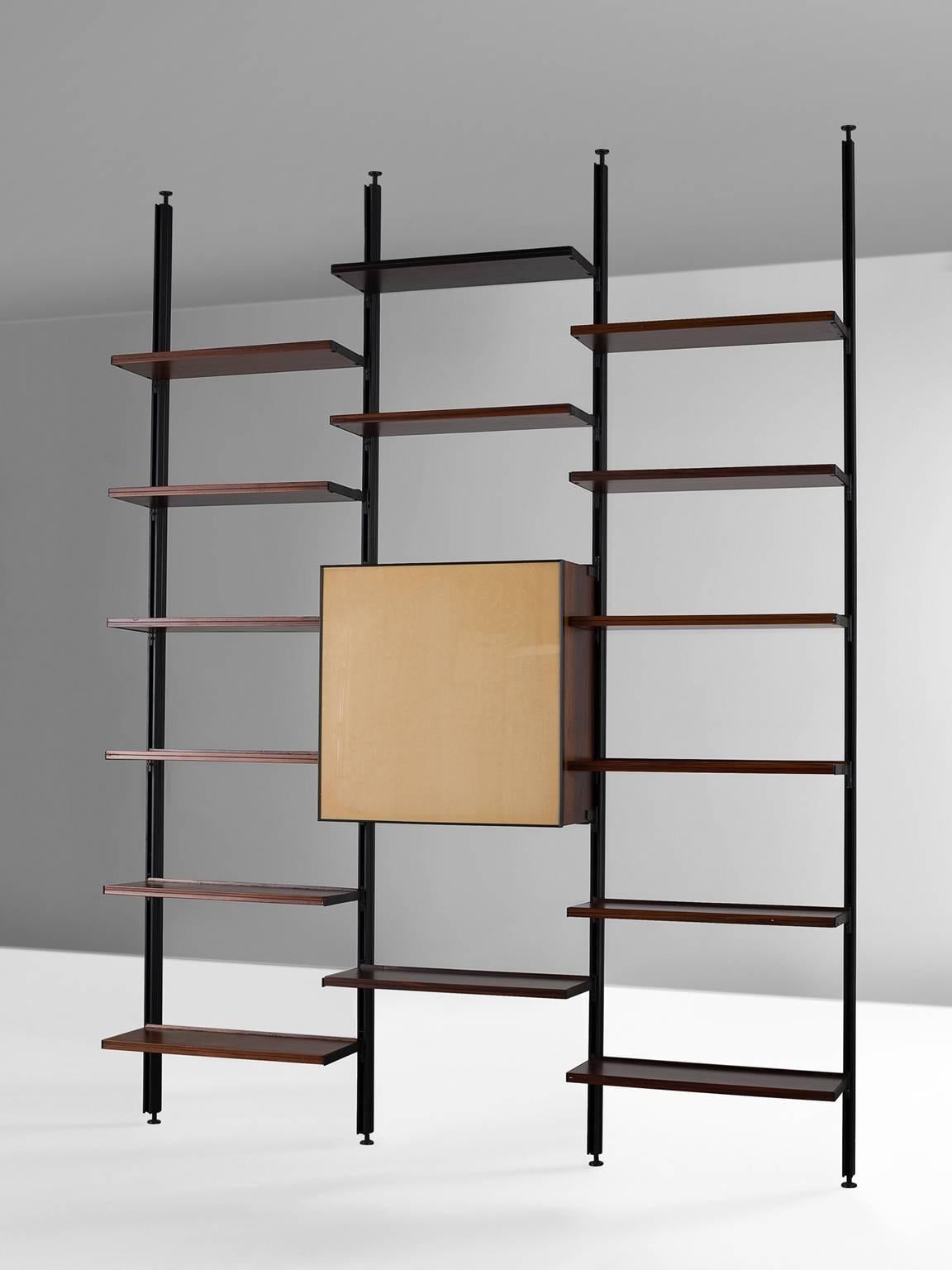 Bookcase, in metal and rosewood, by Osvaldo Borsani for Tecno, Italy, 1950s.

This E22 wall unit by Borsani for Tecno features fifteen shelves and one cabinet. According to Osvaldo Borsani the home needs to be orderly, comfortable and easily