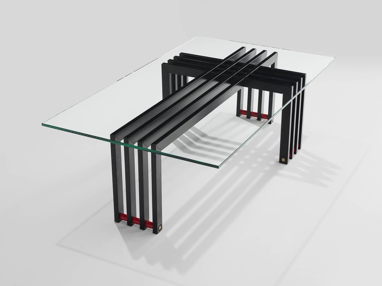 Coffee table with glass and steel, Europe, 1970s.

This sculptural coffee table with transparent glass top and geometric frame and horizontal red slats as a foot. Four iron slats bend form a cross with another four slats of metal. This sculptural