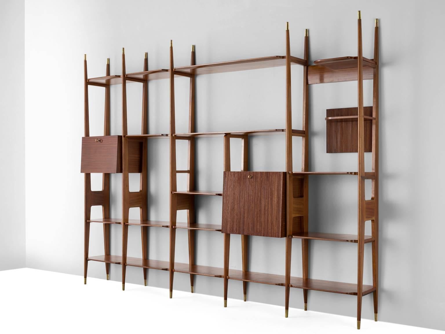 Cabinet, in brass and walnut, Italy, 1950s. 

This delicate Italian wall unit is executed the style of Ico Parisi, Paolo Buffa and Vittorio Dassi on subtle tapered legs that are identical to those at the top. Especially the brass feet and tops