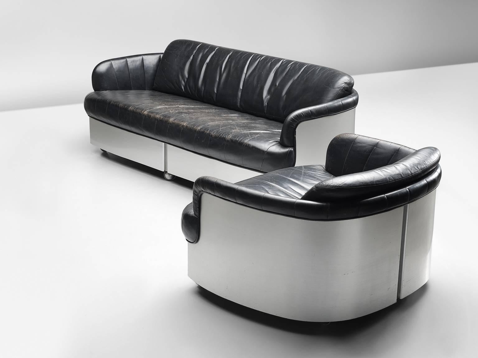 Sofa by Durlet, 'Patina' model, in leather and chrome, Belgium, 1970s. 

Sturdy and highly comfortable three-seat sofa and combined lounge chair. This slick and comfortable lounge set is executed with black leather and chromed steel. The rounded