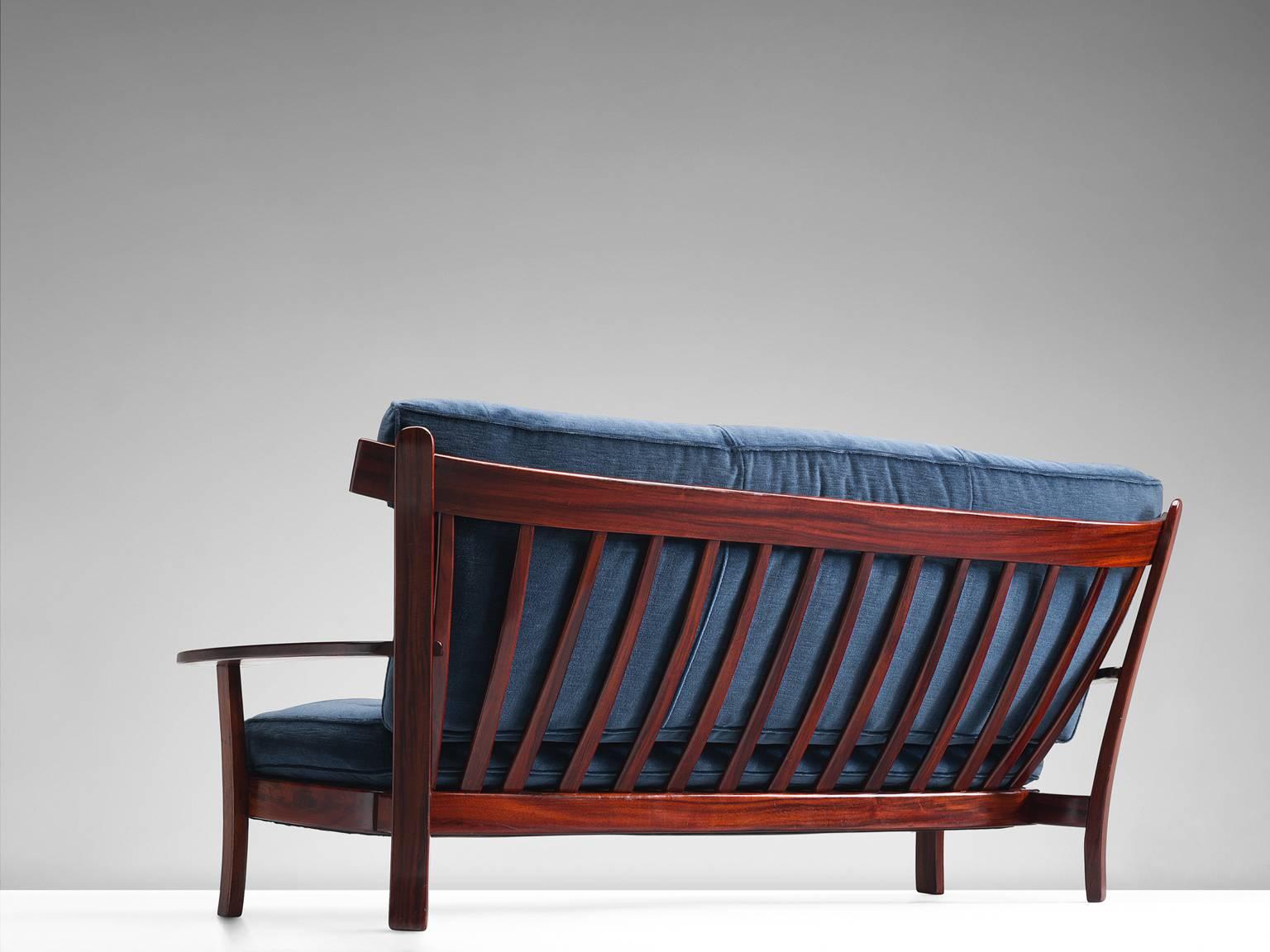 Sofa, rosewood, velvet, Brazilian design, European execution, 1960s.

This settee is executed in Brazilian rosewood and velvet and holds several well-constructed details such as the slatted back and the use of slender and delicate slats of rosewood