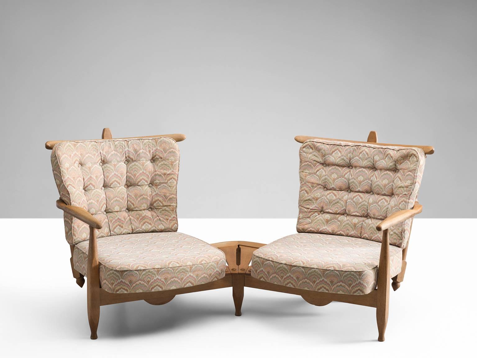 Lounge chairs in oak, beige floral upholstery by Guillerme et Chambron, France, 1940s. 

Guillerme and Chambron are known for their high quality solid oak furniture, from which this is another great example. The curved slatted back makes an elegant