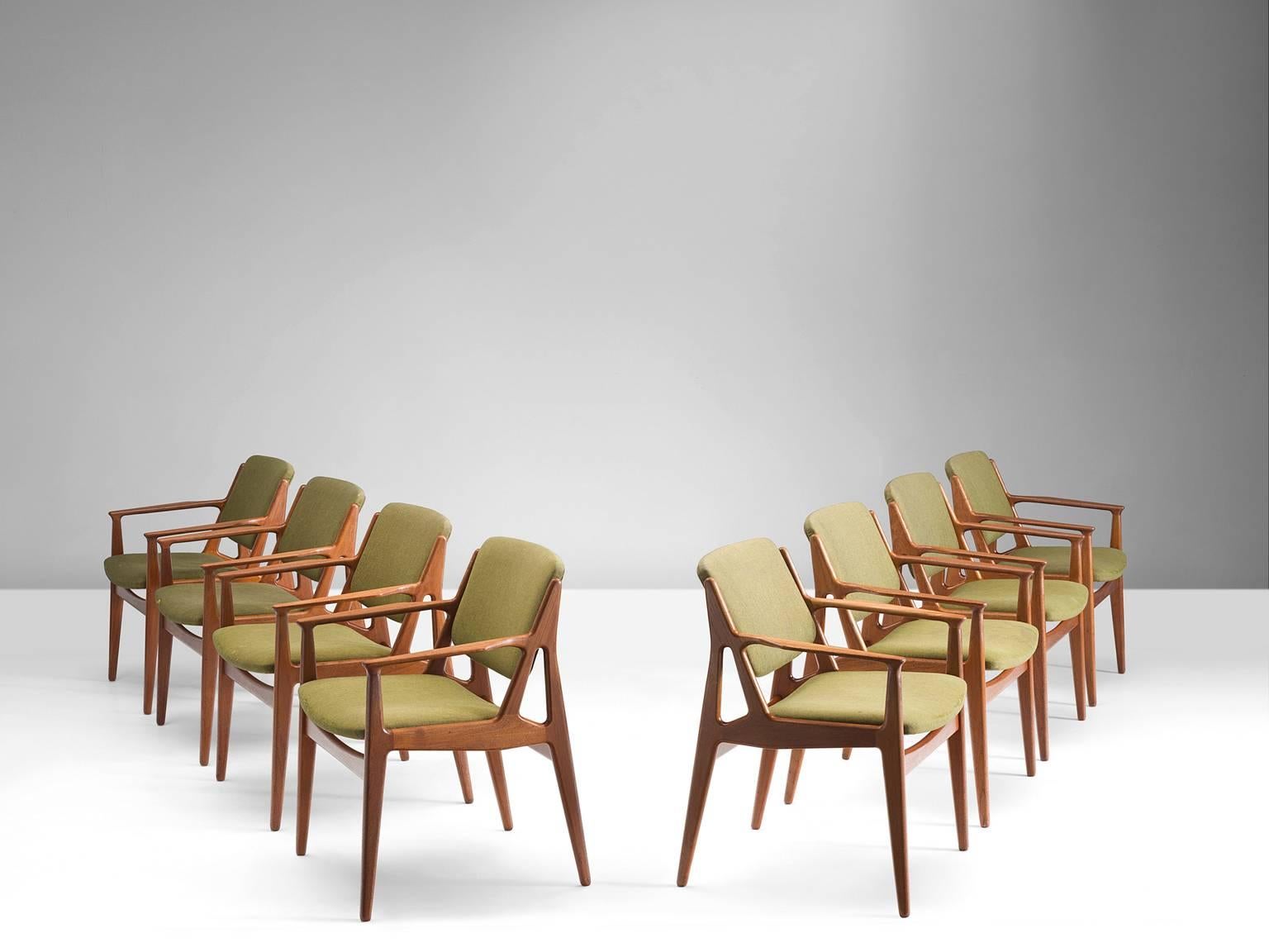 Eight dining chairs, teak and fabric designed by Arne Vodder for Vamo Sonderborg, Denmark, 1960s.

These sensuous armchairs have been restored with olive green fabric upholstery. The sculptural frame is what makes these Danish chairs so unique.
